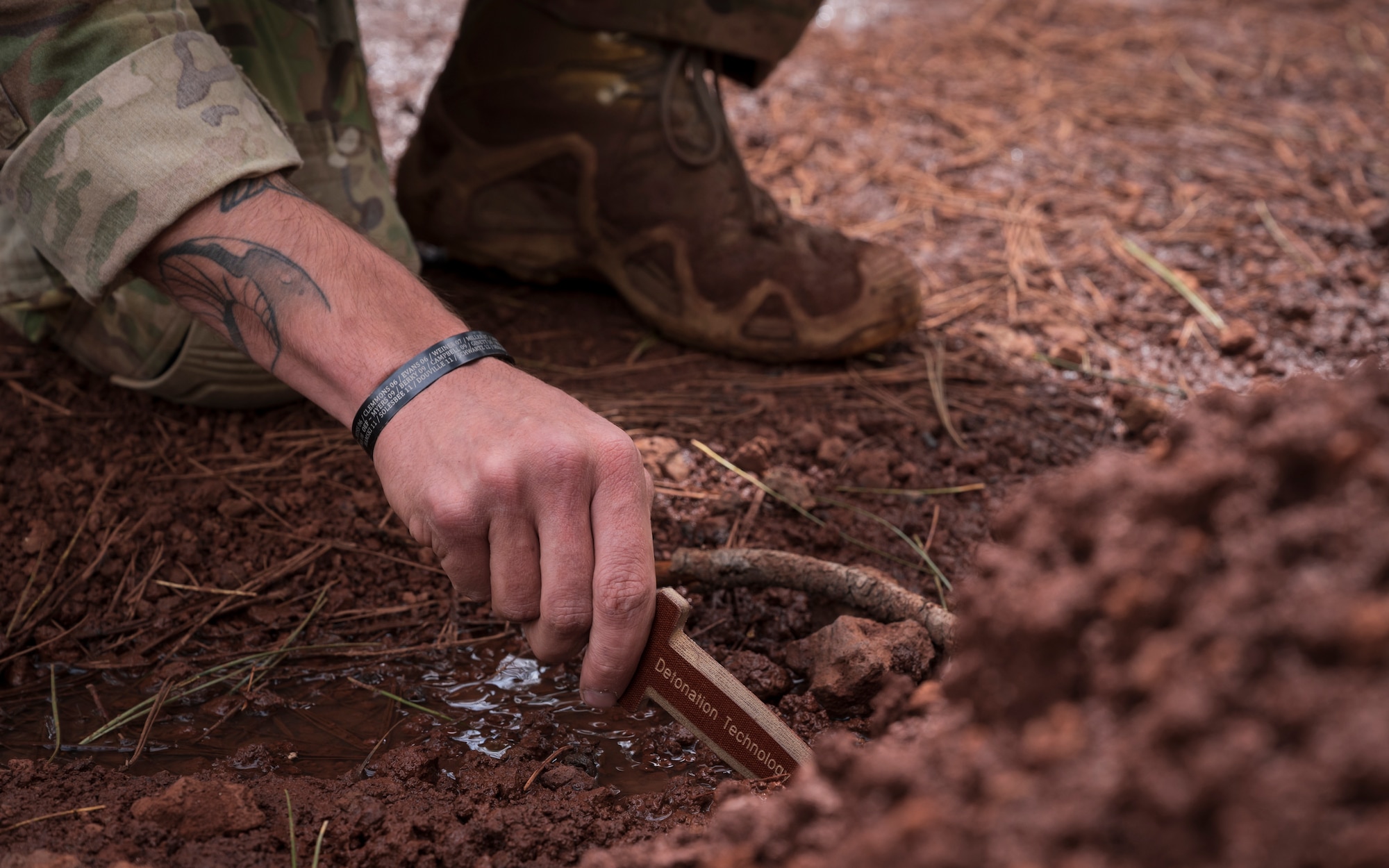 U.S. Air Force Tech. Sgt. Tyler Paul, 56th Civil Engineer Squadron Explosive Ordnance Disposal flight technician, digs through soil with a non-conductive probe at Camp Navajo, Arizona, April 12, 2023.