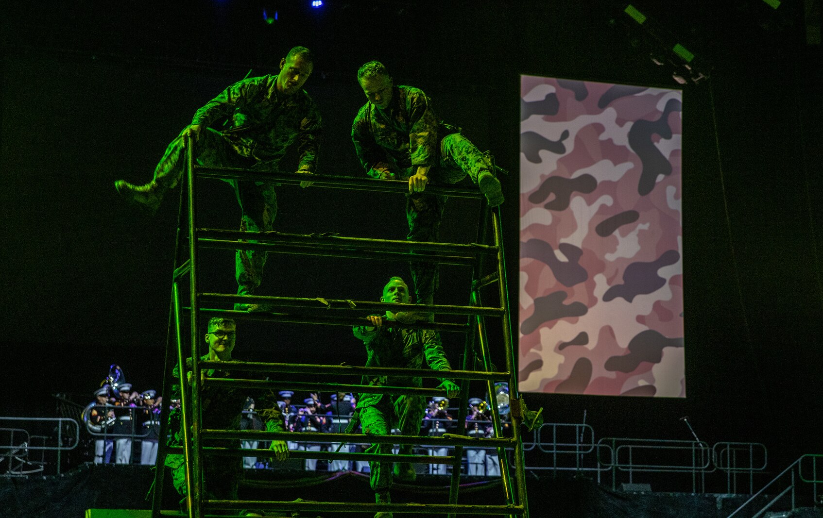 U.S. Marines with Marine Corps Security Force Regiment, Naval Weapons Station, Yorktown, Virginia, complete a simulated obstacle course during the Virginia International Tattoo in Norfolk, Virginia, April 19, 2023. The Virginia International Tattoo is an annual military music and arts festival featuring performances by military bands, drill teams, dancers, and artists from around the world. The event creates a sense of camaraderie and mutual respect among the participants, who come from different branches of the military and different countries, but share a common commitment to service and sacrifice. (U.S. Marine Corps Photo by Lance Cpl. Kayla LeClaire)