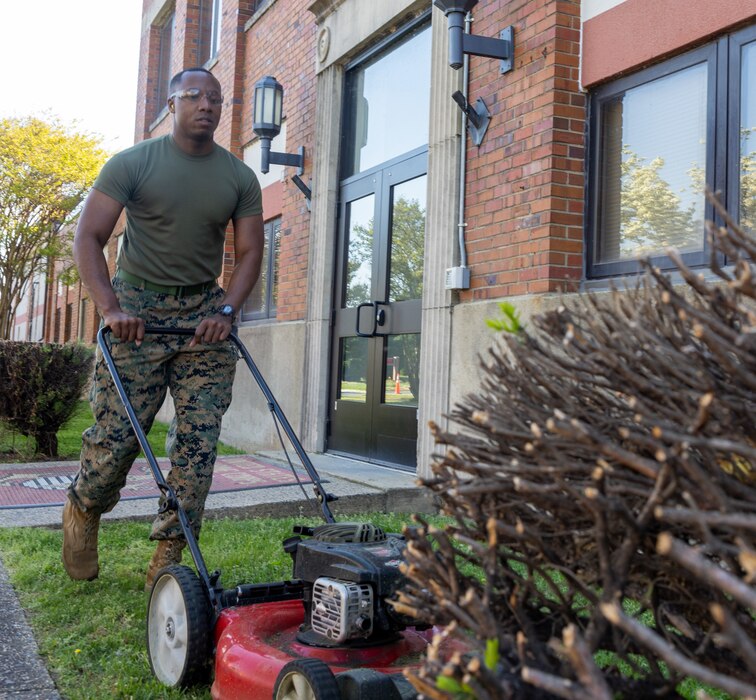 U.S. Marine Corps Lance Cpl. Christopher Zincke, a combat graphics specialist with Security Battalion, mows a lawn during Spring Clean-up at the Security Battalion Headquarters Company office on Marine Corps Base Quantico, Virginia, April 20, 2023. The Marines participated in the Spring Clean-up in order to maintain a safe, healthy, and effective environment for all Marines, Sailors, and government employees who work and live on base. (U.S. Marine Corps photo by Lance Cpl. Jeffery Stevens)