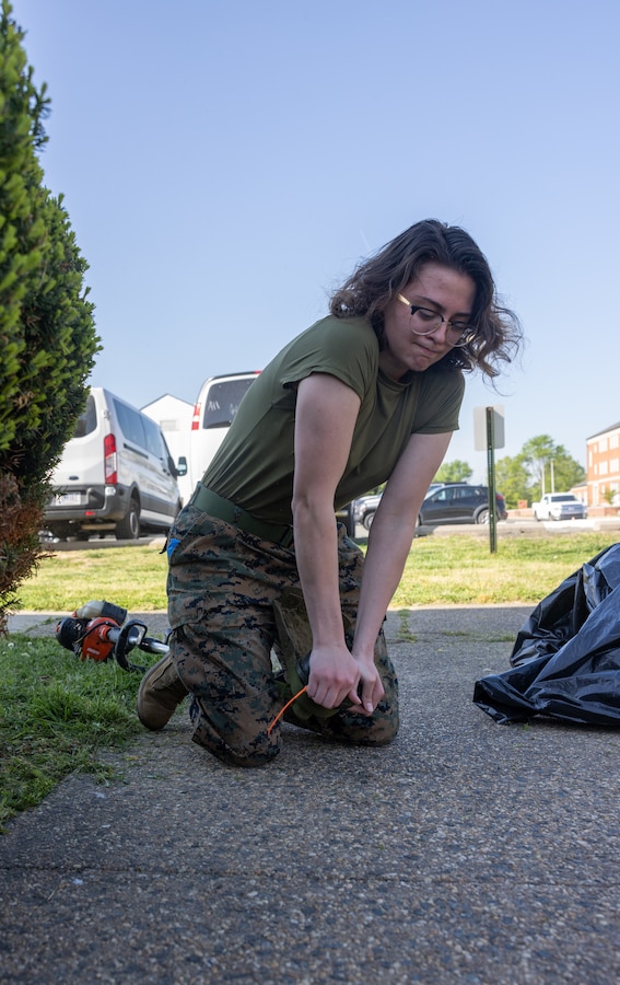 U.S. Marine Corps Lance Cpl. Chloe Lawless, a legal services specialist with Security Battalion, sets up a weed eater during Spring Clean-up at the Security Battalion Headquarters Company office on Marine Corps Base Quantico, Virginia, April 20, 2023. The Marines participated in the Spring Clean-up in order to maintain a safe, healthy, and effective environment for all Marines, Sailors, and government employees who work and live on base. (U.S. Marine Corps photo by Lance Cpl. Jeffery Stevens)