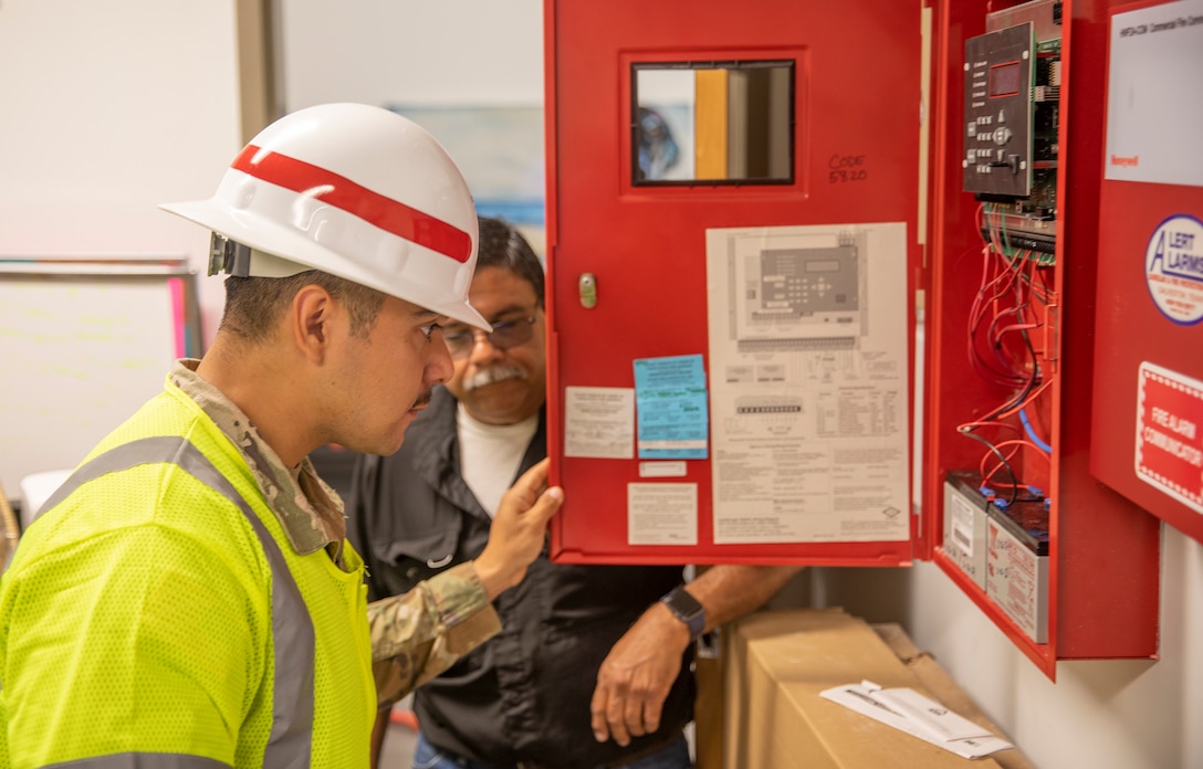 Sgt. Antonio Vargas, with the 249th Engineering Battalion, inspects a fire alarm panel in the Bayside Community Center.