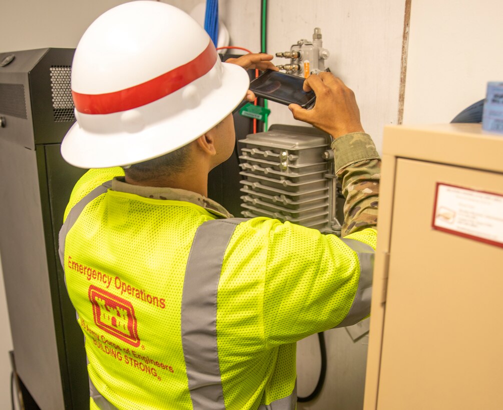 Sgt. Antonio Vargas, with the 249th Engineering Battalion, inspects electrical equipment in Bayside Community Center.