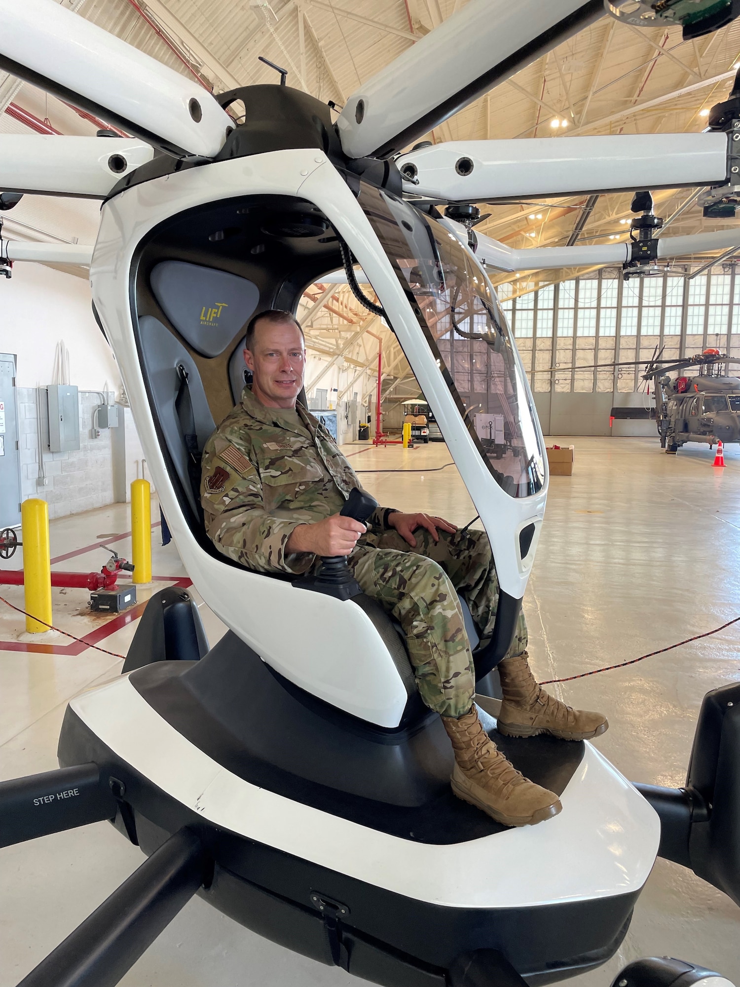 CMSgt. Christopher Griste, Command Chief, Air Force Operational Test and Evaluation Center, checks out an electric vertical take-off and landing aircraft connected to a simulator at Duke Field AFS, Fla., during a visit to AFOTEC Detachment 5’s Operation Location at Hurlburt Field, Fla. The eVTOL is a variety of vertical take-off and landing aircraft that uses electric power to hover, take off, and land vertically.