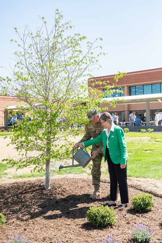 Mrs. Roberta Yourtee and Transatlantic Middle East District Commander, COL Philip Secrist, conduct a ceremonial watering of the memorial tree honoring her husband at the headquarters of the U.S. Army Corps of Engineers Transatlantic Middle East District. The dedication of the tree was part of a retiree appreciation event held 20 April. Yourtee’s husband, Colonel Leon R. Yourtee, III, was a previous District commander who passed away in 1993 while in command of the District.