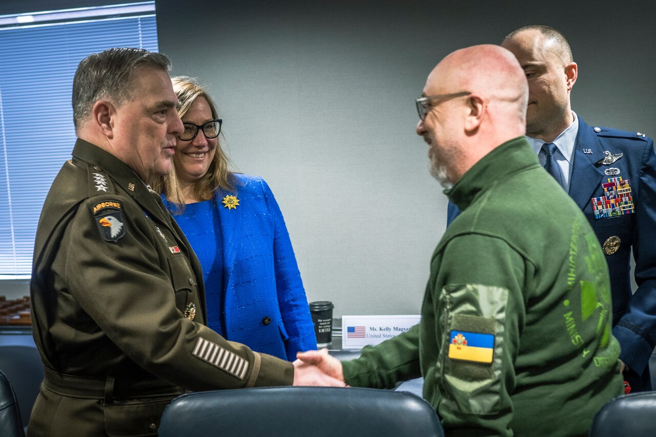 Two men shake hands.