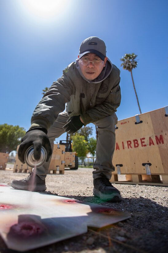 Jimmy Trinidad, a Distribution Process Worker for DDXX, marks the ground with spray paint for an AirBeam during the DLA Distribution Expeditionary Academy on April 19, at DLA Distribution San Joaquin. Photo by Julian Temblador.