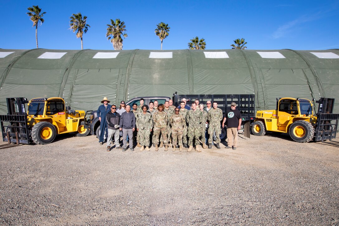 DLA Distribution Expeditionary reservists and civilians pose for a photo in front of an AirBeam tent during the DLA Distribution Expeditionary Academy on April 21, at DLA Distribution San Joaquin. Photo by Julian Temblador.