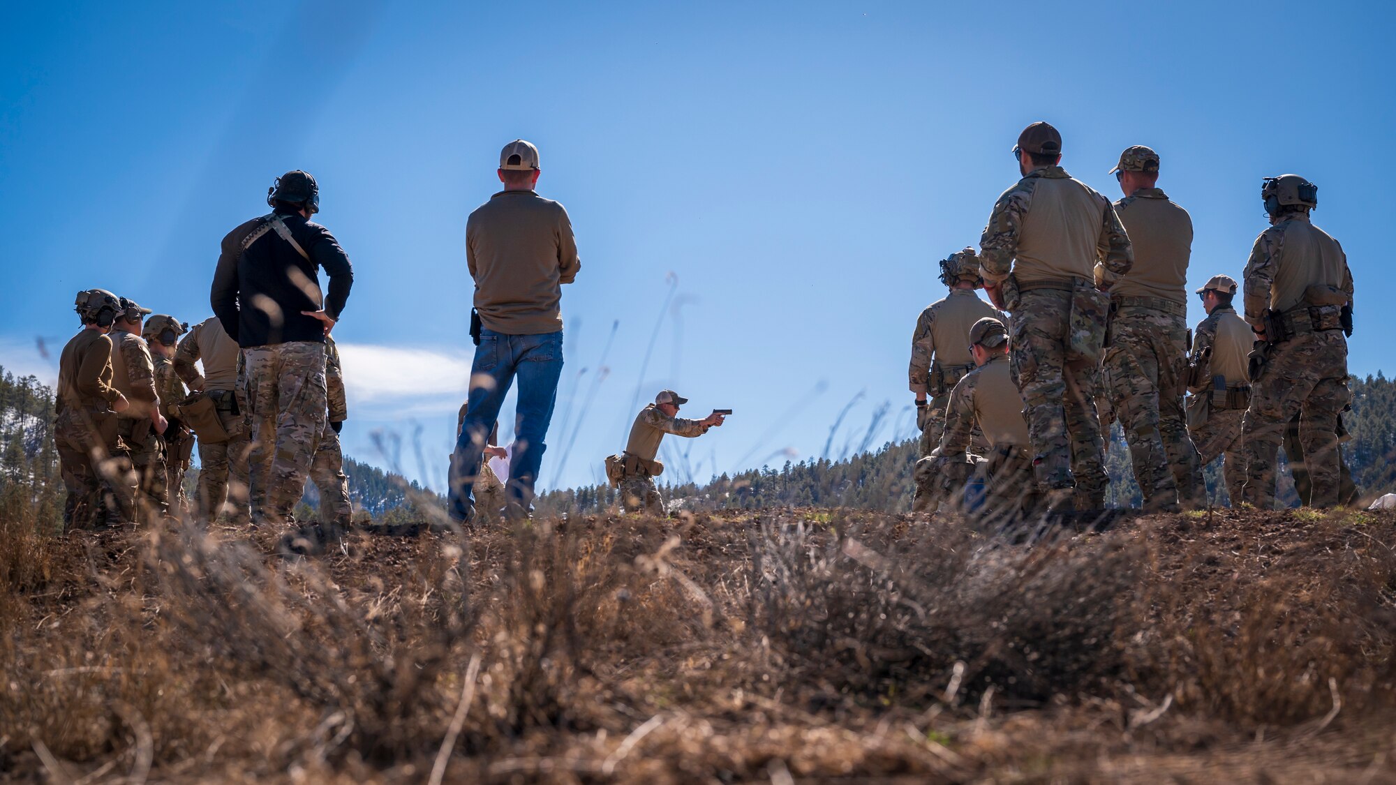 U.S. Air Force Staff Sgt. Jack Jorgensen, 56th Civil Engineer Squadron Explosive Ordnance Disposal flight technician, demonstrates firing techniques with an M18 pistol on a firing range at Camp Navajo, Arizona, April 10, 2023.