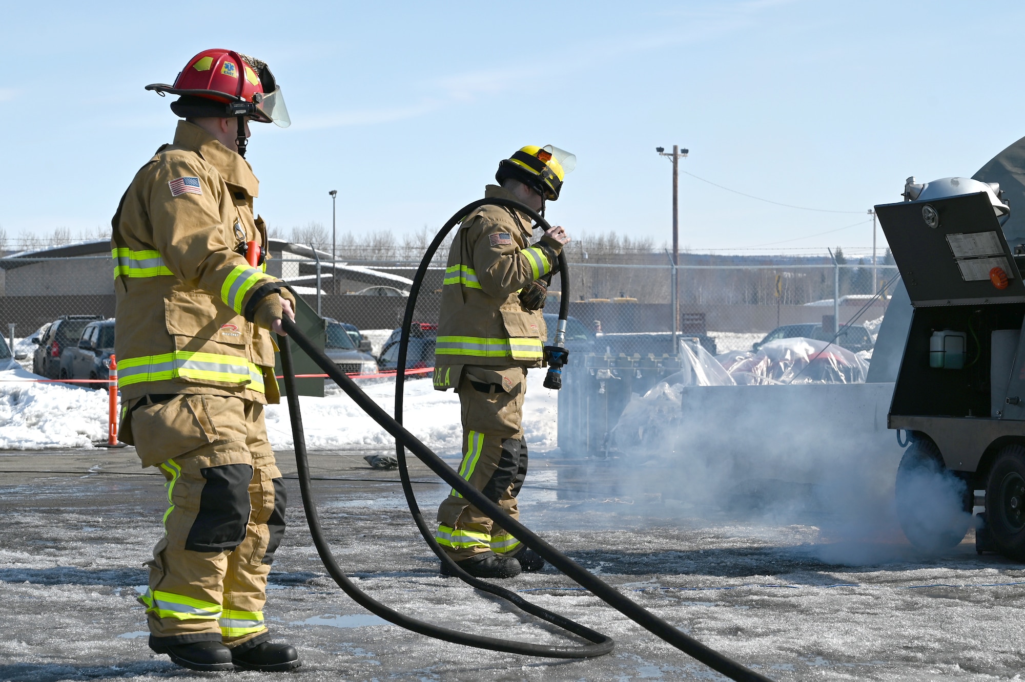 U.S. Airmen assigned to the 354th Civil Engineering Squadron fire department put out a simulated fire during readiness exercise Arctic Gold 23-2 April 19, 2023 at Eielson Air Force Base, Alaska. The Arctic Gold 23-2 provided the opportunity for Multi-Capable Airmen to practice and refine their skills. Multi-capable Airmen are a key component to the ACE concept where Airmen are trained as cross-functional teams in skill sets outside their core Air Force specialty to provide support in an expeditionary deployed environment. (U.S. Air Force photo by Staff Sergeant Danielle Sukhlall)