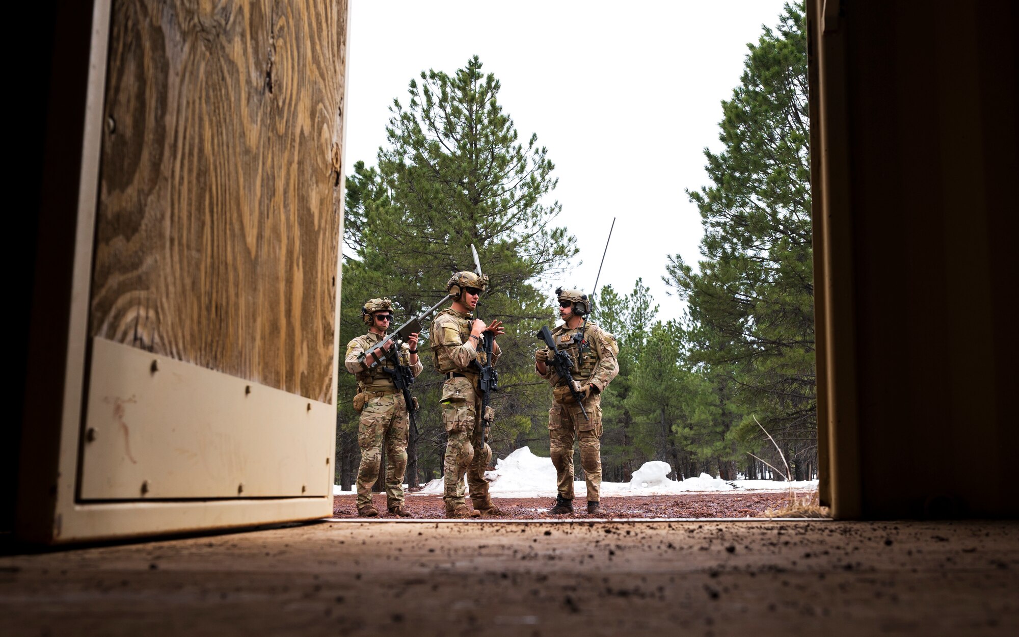 U.S. Air Force Airmen assigned to the 56th Civil Engineer Squadron Explosive Ordnance Disposal flight, discuss plans to investigate a storage unit containing suspicious materials during a training scenario at Camp Navajo, Arizona, April 12, 2023.