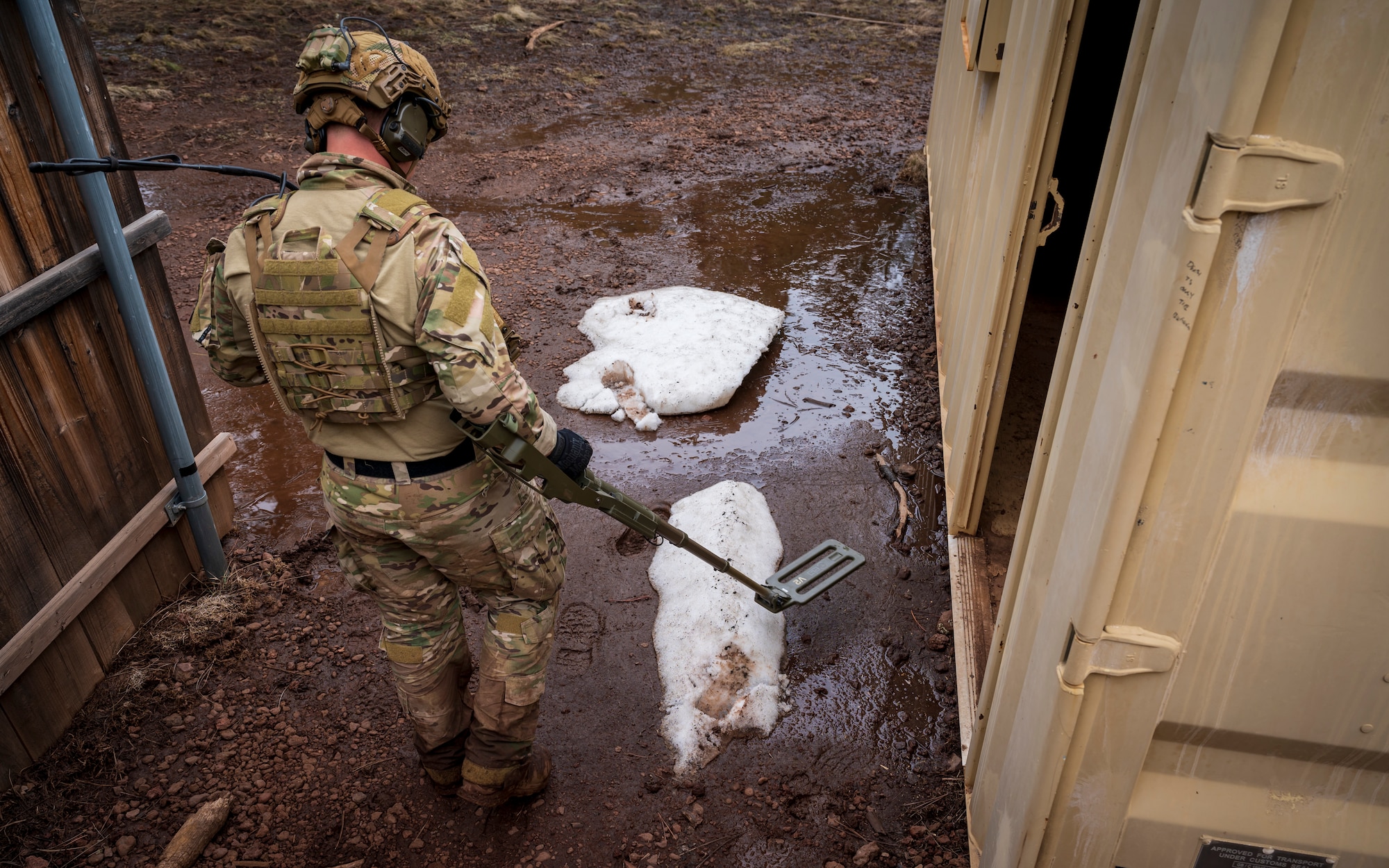 U.S. Air Force Staff Sgt. Brandon Verwey, 56th Civil Engineer Squadron Explosive Ordnance Disposal flight technician, sweeps for unexploded ordnance inside a mock village during a training scenario at Camp Navajo, Arizona, April 12, 2023.