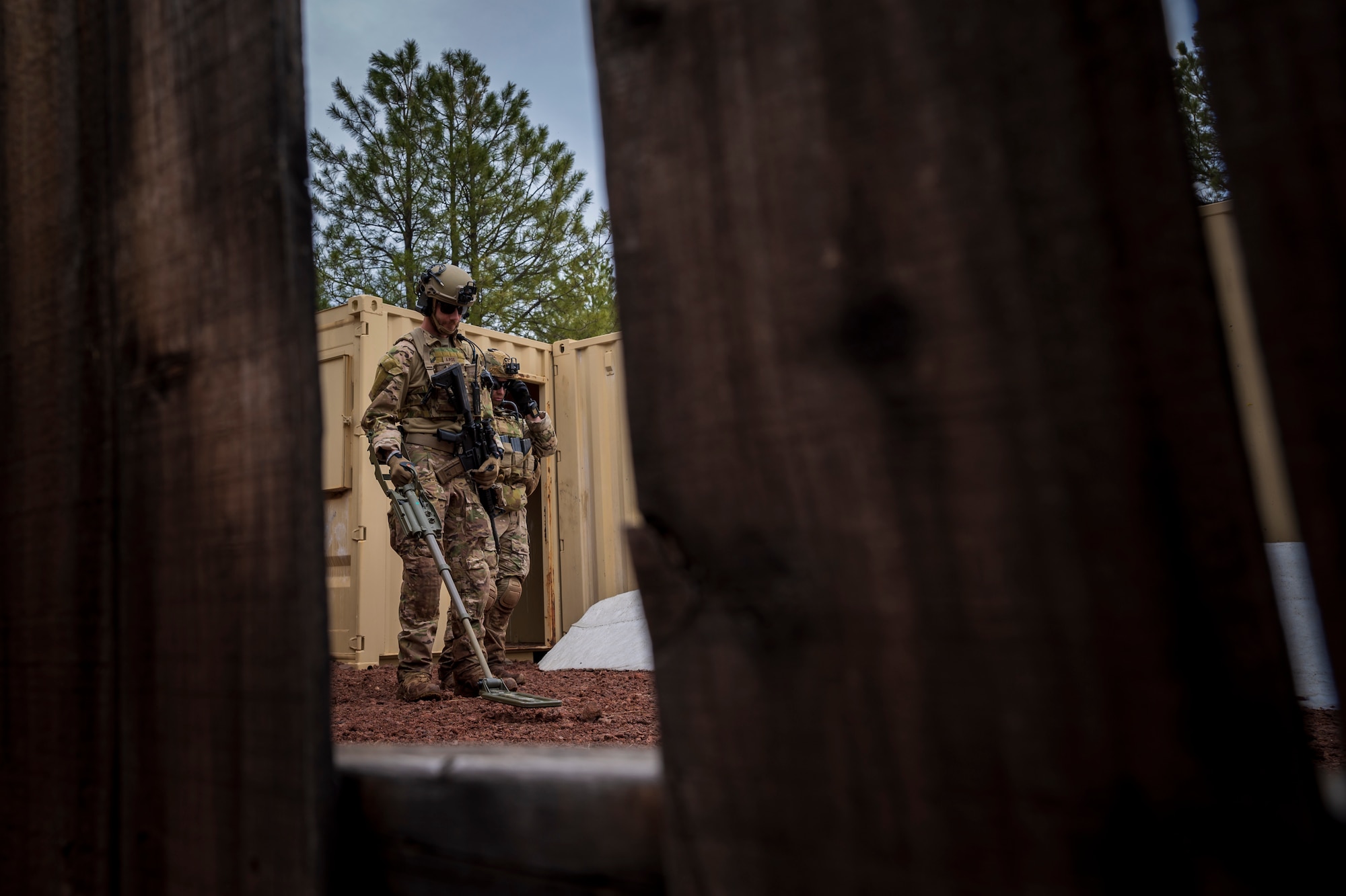 U.S. Air Force Airman 1st Class Jessey Mclain, 56th Civil Engineer Squadron Explosive Ordnance Disposal flight technician, sweeps for unexploded ordnance inside a mock village during a training scenario at Camp Navajo, Arizona, April 12, 2023.
