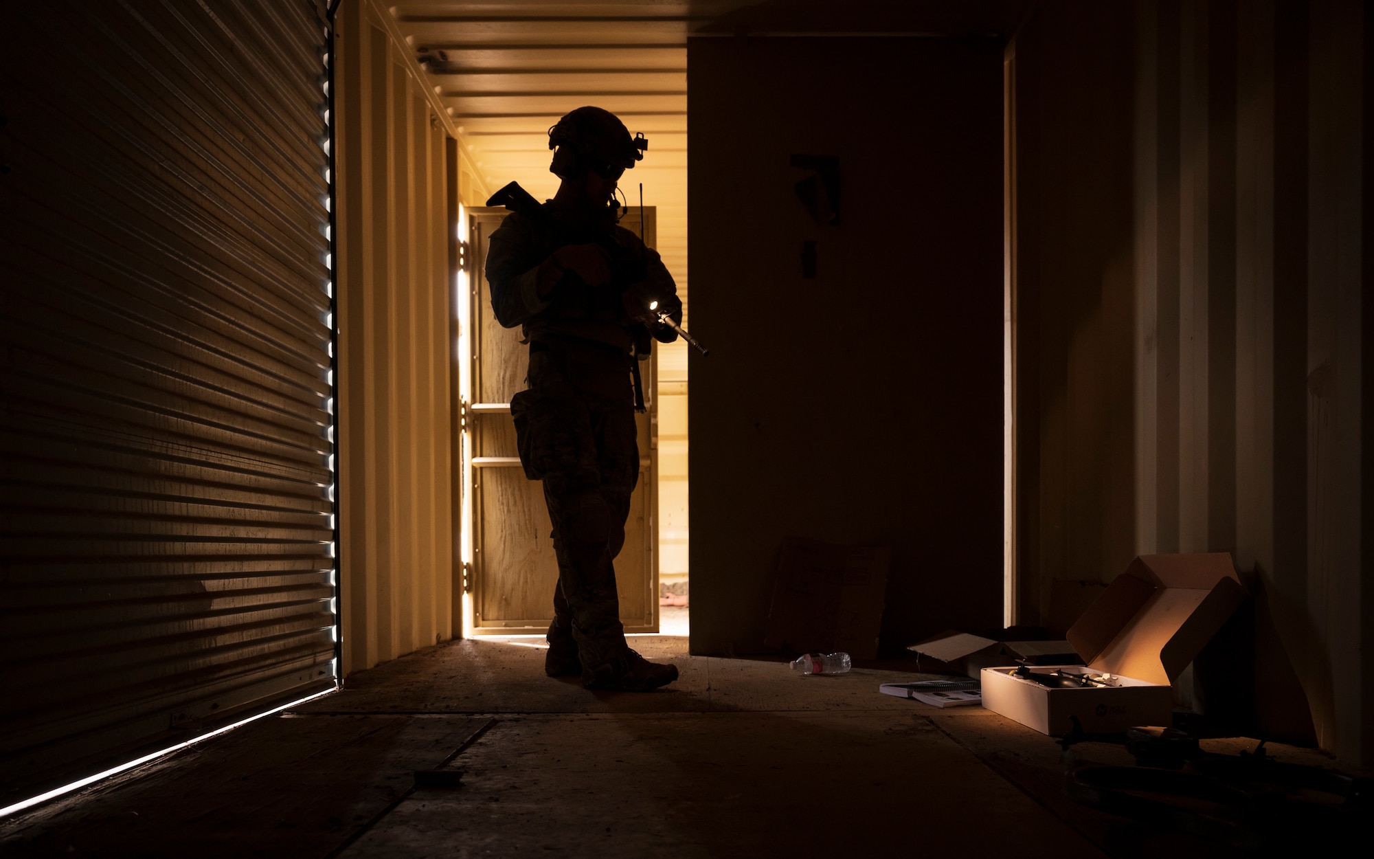 U.S. Air Force Tech. Sgt. Tyler Paul, 56th Civil Engineer Squadron Explosive Ordnance Disposal flight technician, investigates suspicious materials inside a storage unit during a training scenario at Camp Navajo, Arizona, April 12, 2023.