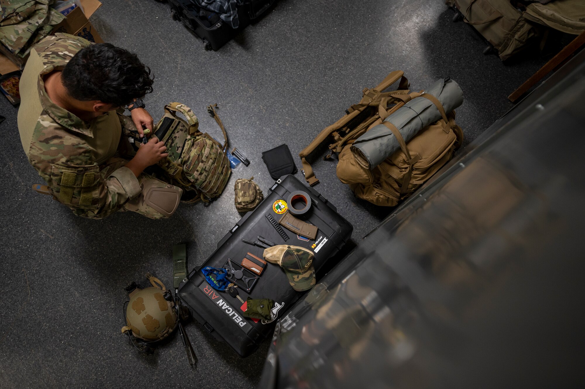 U.S. Air Force Senior Airman Nestor Guevara-Penella, 56th Civil Engineer Squadron Explosive Ordnance Disposal flight technician, prepares gear in a barracks bay at Camp Navajo, Arizona, April 10, 2023.