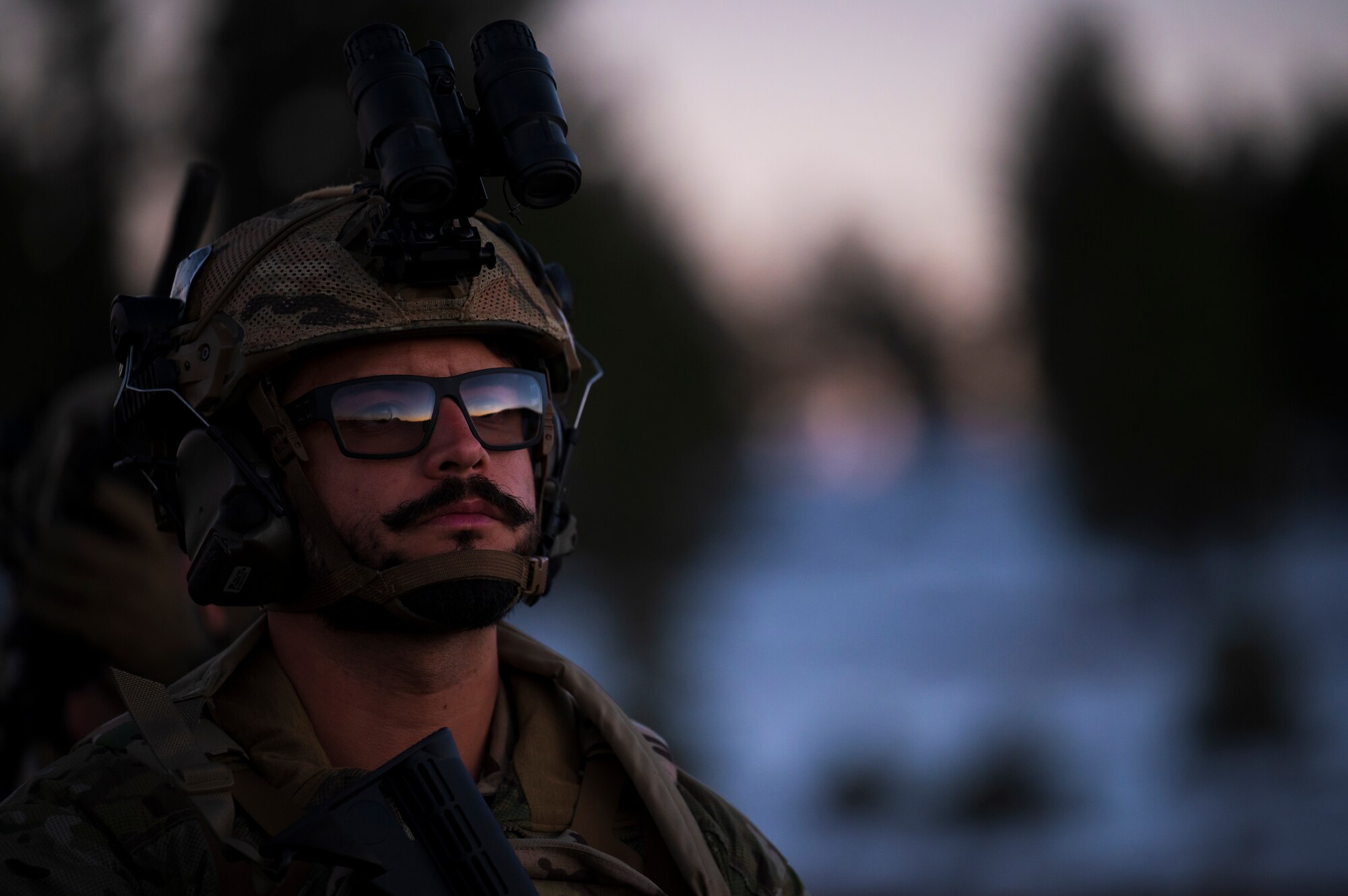 U.S. Air Force Staff Sgt. Antonio Ramirez, 56th Civil Engineer Squadron Explosive Ordnance Disposal flight technician, listens to instruction on a firing range at Camp Navajo, Arizona, April 10, 2023.