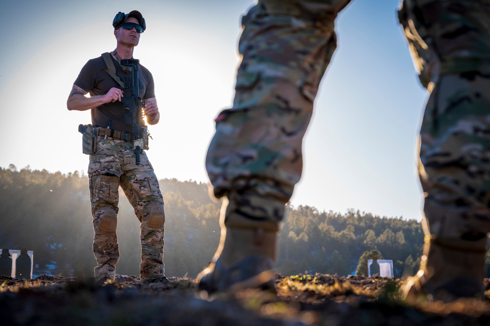 U.S. Air Force Master Sgt. Larry Miller, 56th Civil Engineer Squadron Explosive Ordnance Disposal flight range operations section chief, instructs EOD members on M4 carbine assault rifle techniques on a firing range at Camp Navajo, Arizona, April 10, 2023.