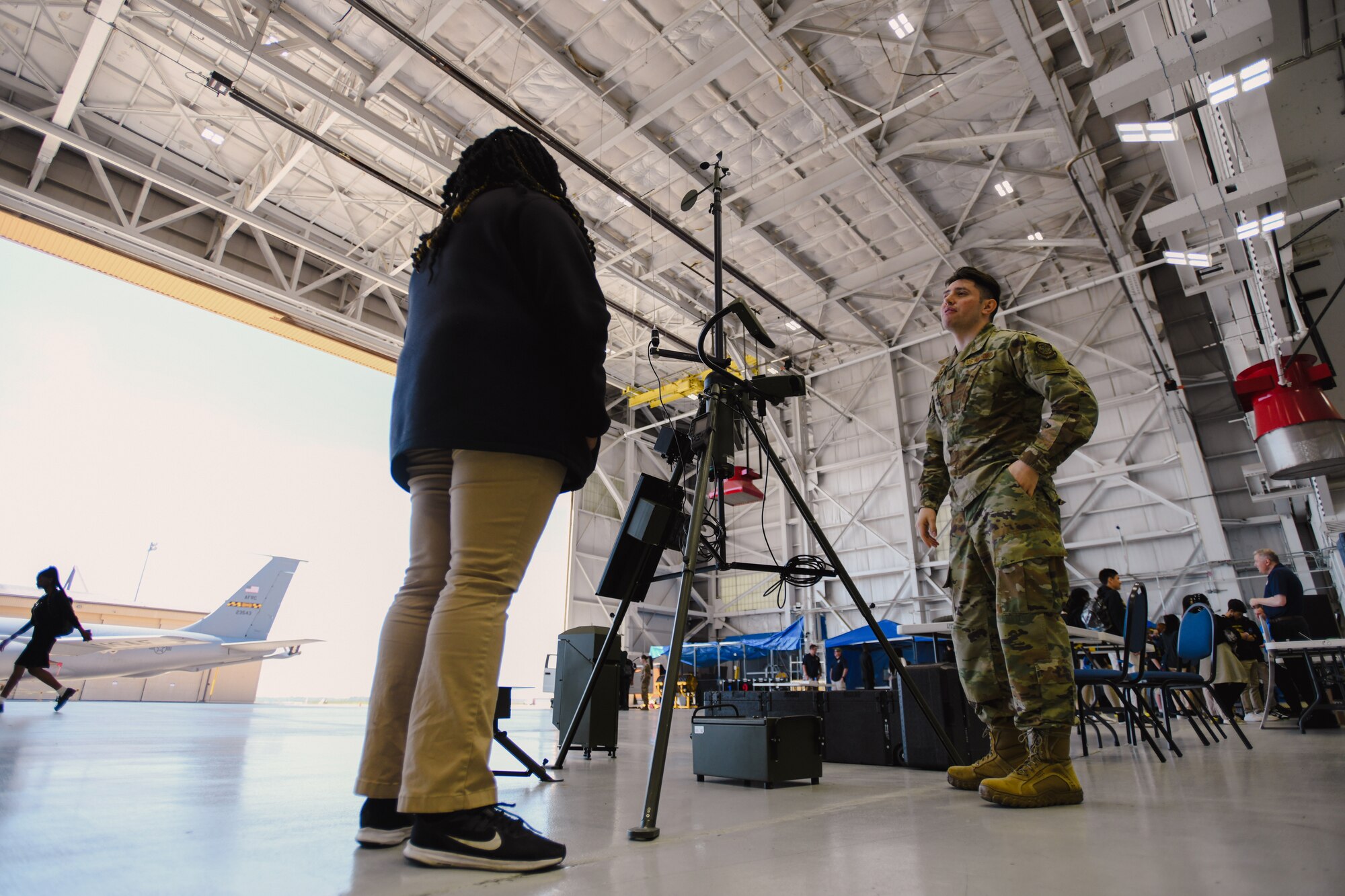 An 89th Operations Support Squadron member teaches a student about a TMQ-53 Tactical Meteorological Observing System during the inaugural Science, Technology, Engineering, Arts, and Math Competition and Exhibition at Joint Base Andrews, Md., April 20, 2023.