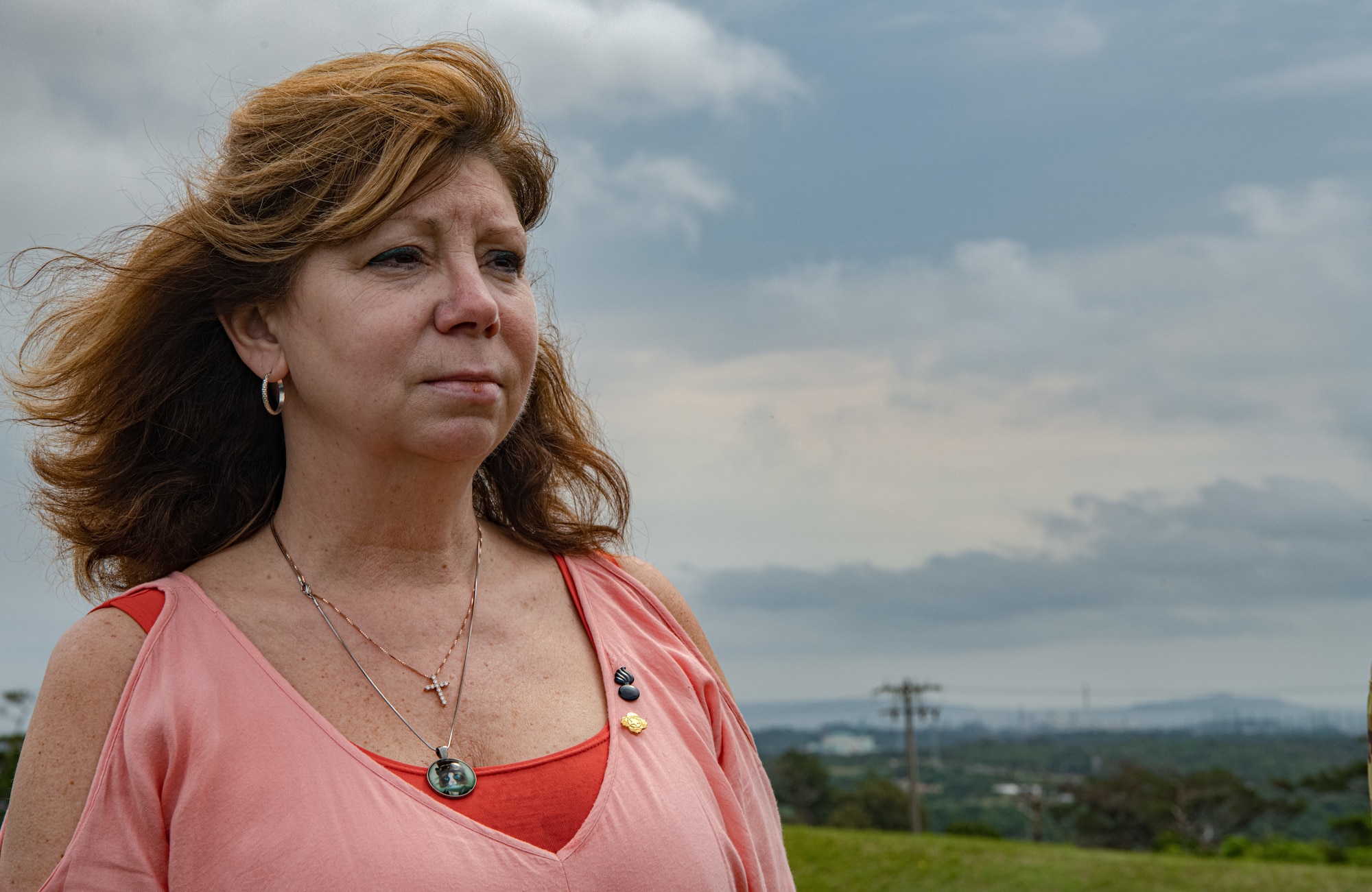 A portrait shot of a woman looking off into the distance.
