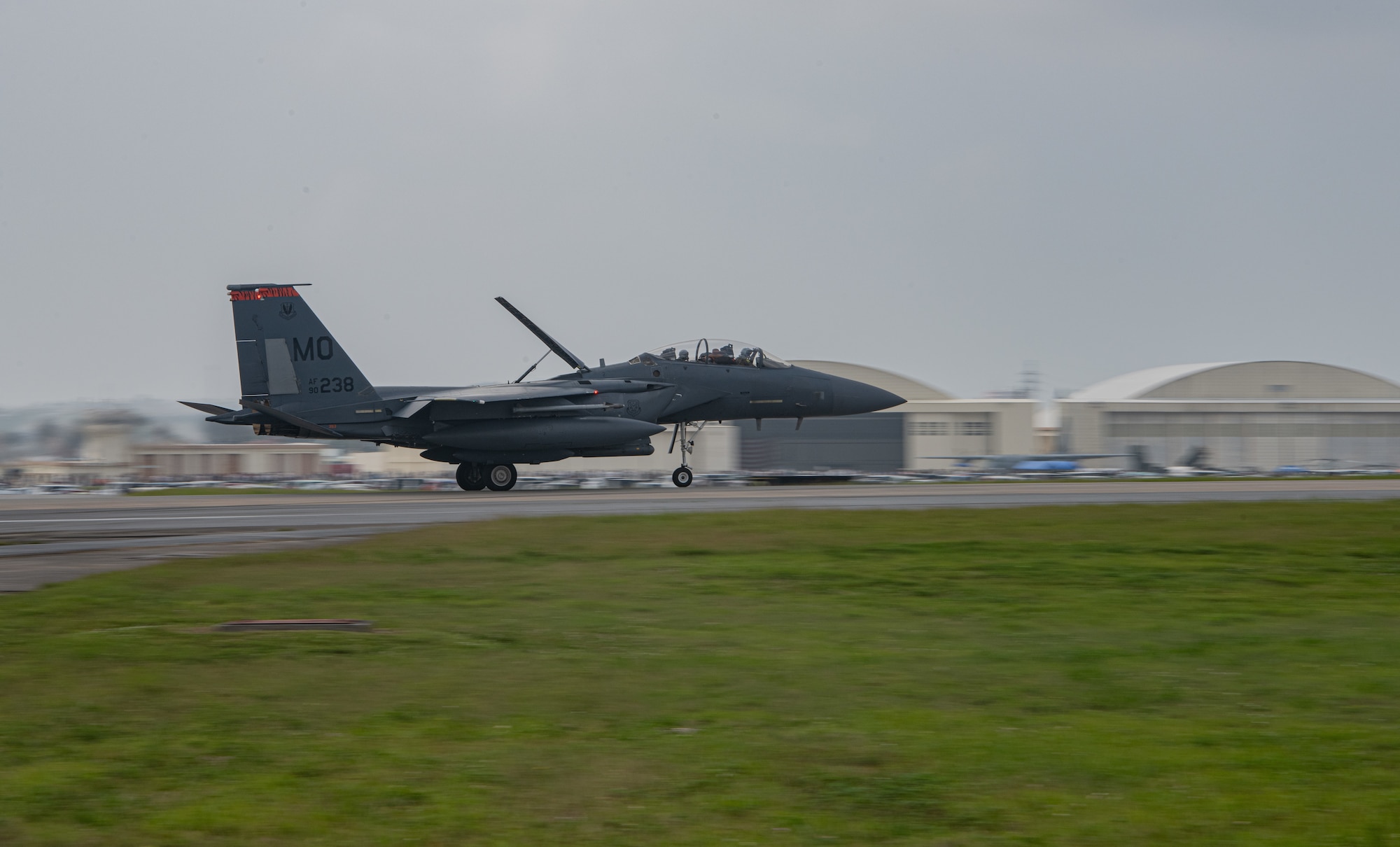 An F-15E lands on a runway.