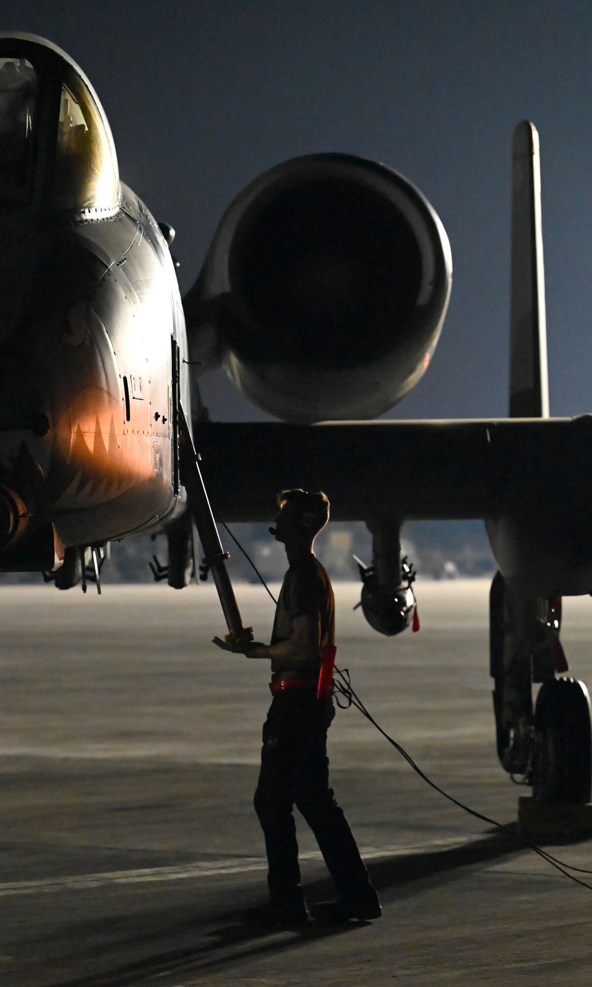 U.S. Air Force Airman 1st Class Dylan Prusso, 75th Expeditionary Fighter Generation Squadron crew chief, replaces the boarding ladder of a 75th Expeditionary Fighter Squadron A-10 Thunderbolt II for a combat sortie in the U.S. Central Command area of responsibility at Al Dhafra Air Base, United Arab Emirates, April 20, 2022. The deployment of A-10s in the region provides additional capability in the Middle East alongside fighter aircraft. This deployment ensures close air support specialists are able to build upon their skills in environments outside of the United States and ensure combat operations remain sharp across the force. (U.S. Air Force photo by Tech. Sgt. Alex Fox Echols III)