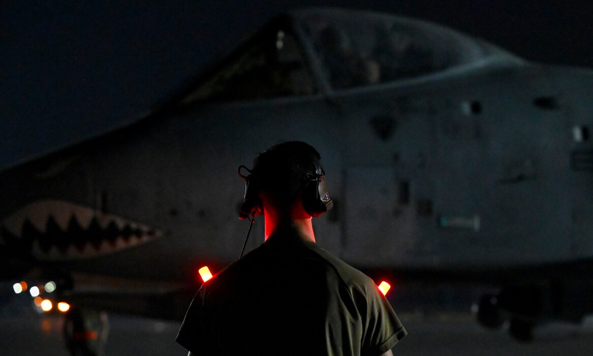 U.S. Air Force Airman 1st Class Dylan Prusso, 75th Expeditionary Fighter Generation Squadron crew chief, prepares to marshall a 75th Expeditionary Fighter Squadron A-10 Thunderbolt II for a sortie in the U.S. Central Command area of responsibility at Al Dhafra Air Base, United Arab Emirates, April 20, 2022. The deployment of A-10s in the region provides additional capability in the Middle East alongside fighter aircraft. This deployment ensures close air support specialists are able to build upon their skills in environments outside of the United States and ensure combat operations remain sharp across the force. (U.S. Air Force photo by Tech. Sgt. Alex Fox Echols III)