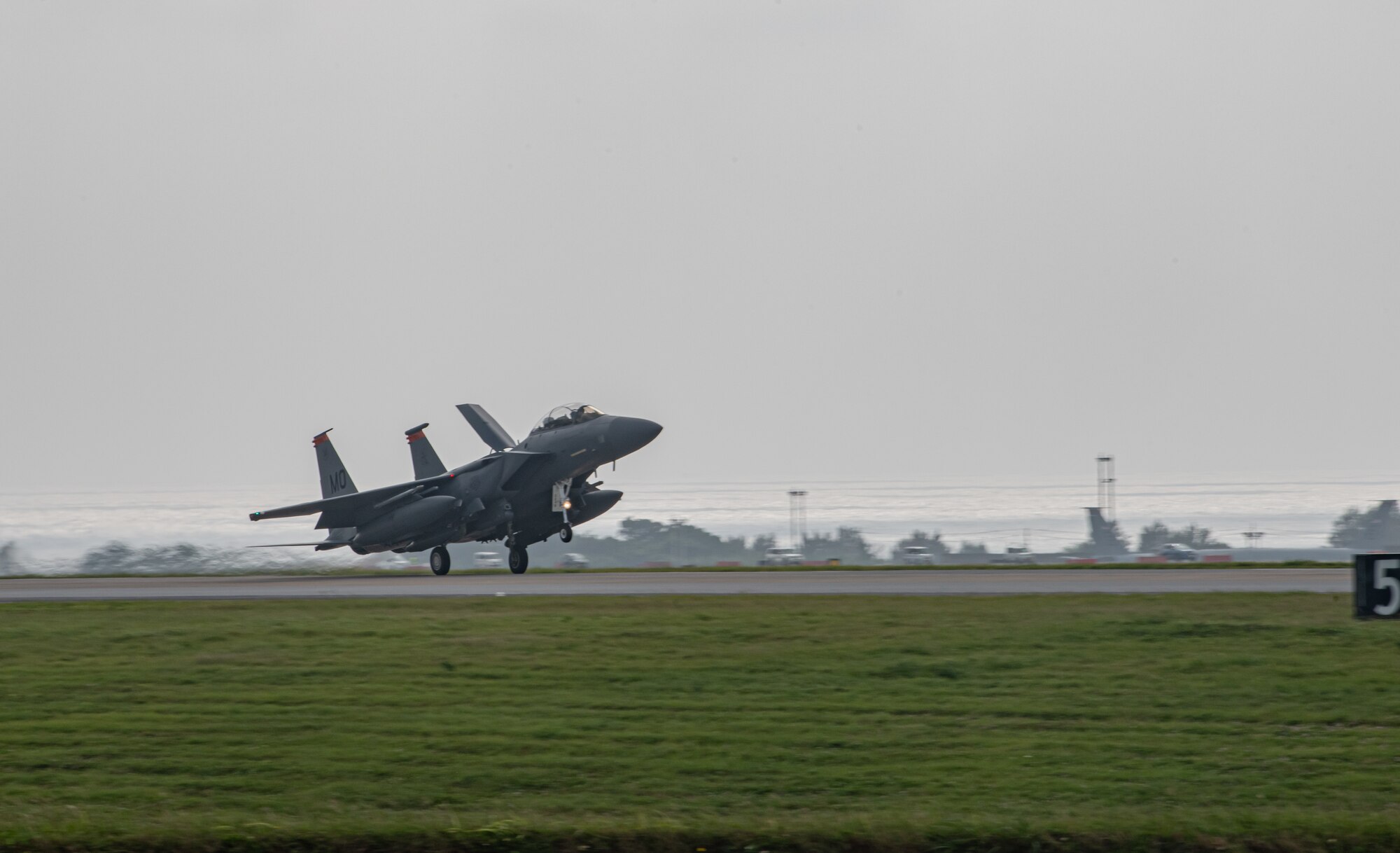 An F-15E lands on a runway.