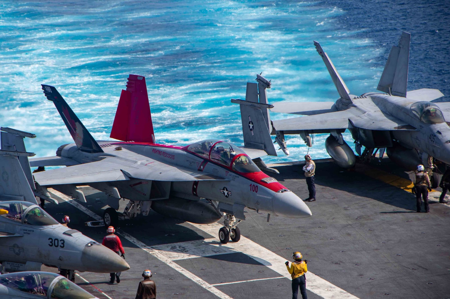 U.S. Navy Capt. Craig Sicola, commanding officer of the aircraft carrier USS Nimitz (CVN 68), front seat, and Cmdr. Luke Edwards, commanding officer of the “Fighting Redcocks” of Strike Fighter Squadron (VFA) 22, taxi across the flight deck of Nimitz in an F/A-18F Super Hornet from VFA-22. Nimitz is in U.S. 7th Fleet conducting routine operations. 7th Fleet is the U.S. Navy's largest forward-deployed numbered fleet, and routinely interacts and operates with allies and partners in preserving a free and open Indo-Pacific region. (U.S. Navy photo by Mass Communication Specialist 3rd Class Emma Burgess)