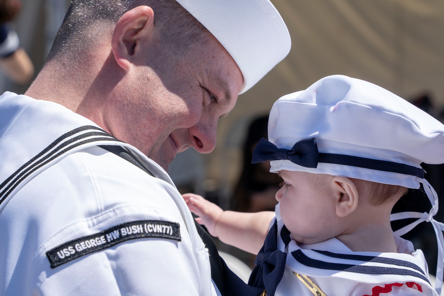 NORFOLK, Va. (April 23, 2023) Electronics Technician 1st Class Karl Kraft, assigned to the Nimitz-class aircraft carrier USS George H.W. Bush (CVN 77), along with the staff of carrier Strike Group (CSG) 10, meets his daughter for the first time after the ship's return to Naval Station Norfolk following an eight-month deployment, April 23, 2023. The George H.W. Bush CSG was deployed to the U.S. Naval Forces Europe area of operations, employed by U.S. Sixth Fleet to defend U.S., allied and partner interests. (U.S. Navy photo by Mass Communication Specialist 2nd Class Anderson W. Branch)