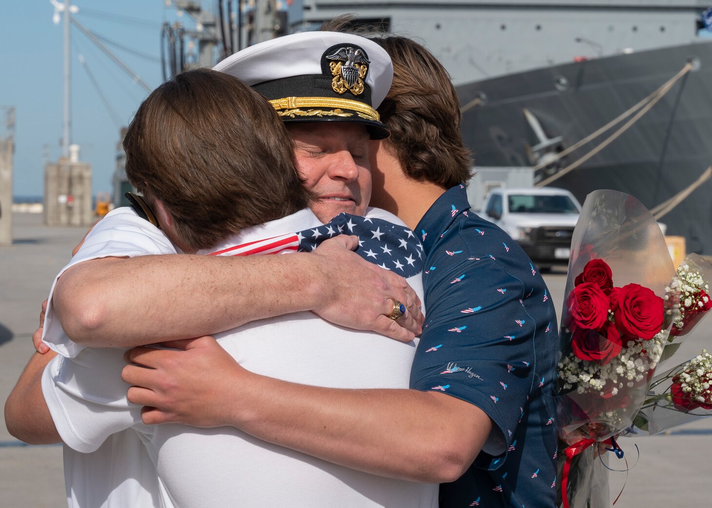 NORFOLK, Va. – Capt. Michael Weeldreyer, commanding officer of the Ticonderoga-class guided-missile cruiser USS Leyte Gulf (CG 55), reunites with his sons on the pier at Naval Station Norfolk following an eight-month deployment with Carrier Strike Group (CSG) 10, April 23, 2023. The George H.W. Bush CSG was deployed to the U.S. Naval Forces Europe area of operations, employed by U.S. Sixth Fleet to defend U.S., allied and partner interests. (U.S. Navy photo by Mass Communication Specialist 1st Class Kris R. Lindstrom)