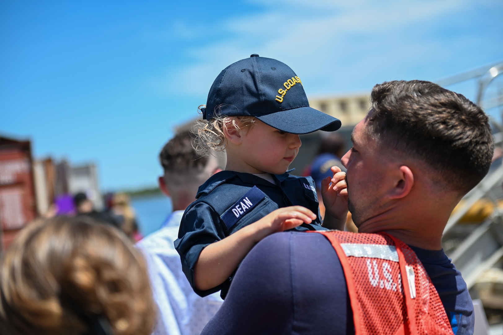 U.S. Coast Guard Petty Officer 1st Class Dylan Dean, an operations specialist assigned to USCGC Stone (WMSL 758), embraces loved ones in North Charleston, South Carolina, April 23, 2023. Stone's crew returned to their home port following a 105-day patrol in the South Atlantic Ocean, Caribbean Sea and Florida Straits. (U.S. Coast Guard photo by Petty Officer 3rd Class Riley Perkofski)