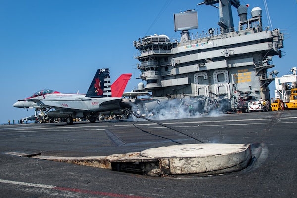 U.S. Navy Capt. Craig Sicola, commanding officer of the aircraft carrier USS Nimitz (CVN 68), front seat, and Cmdr. Luke Edwards, commanding officer of the “Fighting Redcocks” of Strike Fighter Squadron (VFA) 22, make an arrested landing in an F/A-18F Super Hornet from VFA-22 marking the 350,000th time the carrier has landed a fixed-wing aircraft on its flight deck. Nimitz is in U.S. 7th Fleet conducting routine operations. 7th Fleet is the U.S. Navy's largest forward-deployed numbered fleet, and routinely interacts and operates with allies and partners in preserving a free and open Indo-Pacific region. (U.S. Navy photo by Mass Communication Specialist 3rd Class Hannah Kantner)