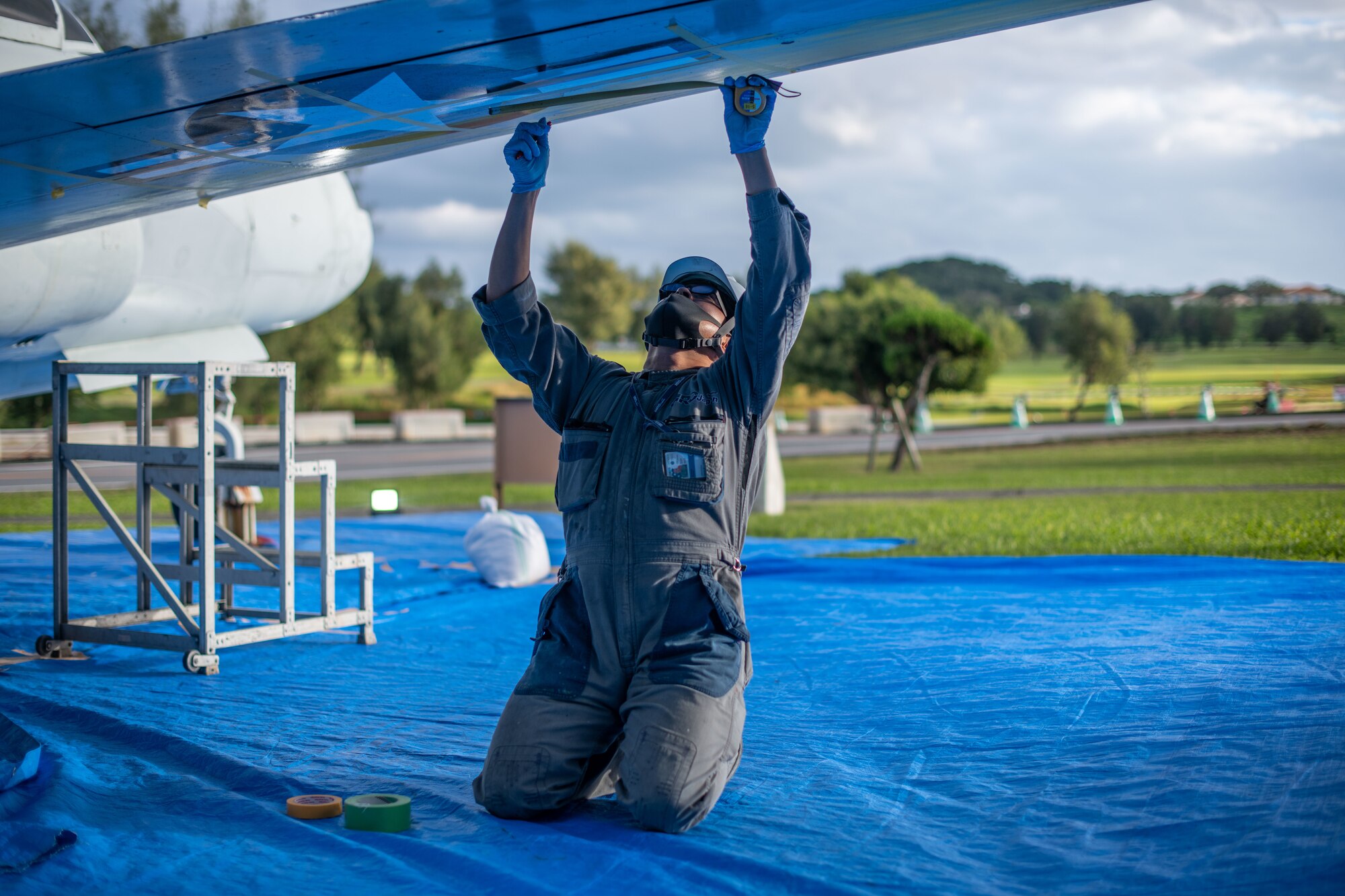 A painter restores a jet.