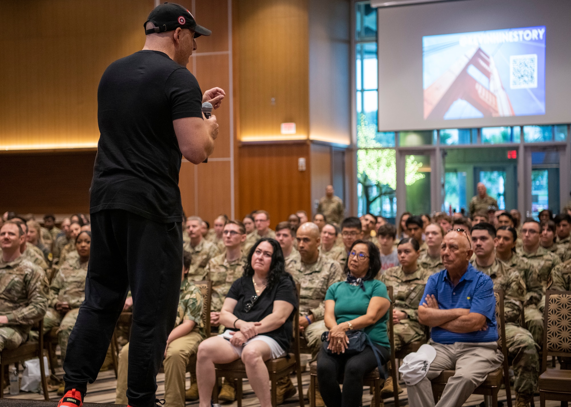 Kevin Hines, a motivational speaker and suicide attempt survivor, talks with Airmen and civilians at Kadena Air Base, Japan, April 19, 2023. Hines explained that everyone has struggles and encouraged Airmen to leverage their support groups and outlets to find help. (U.S. Air Force photo by Airman 1st Class Edward Yankus)