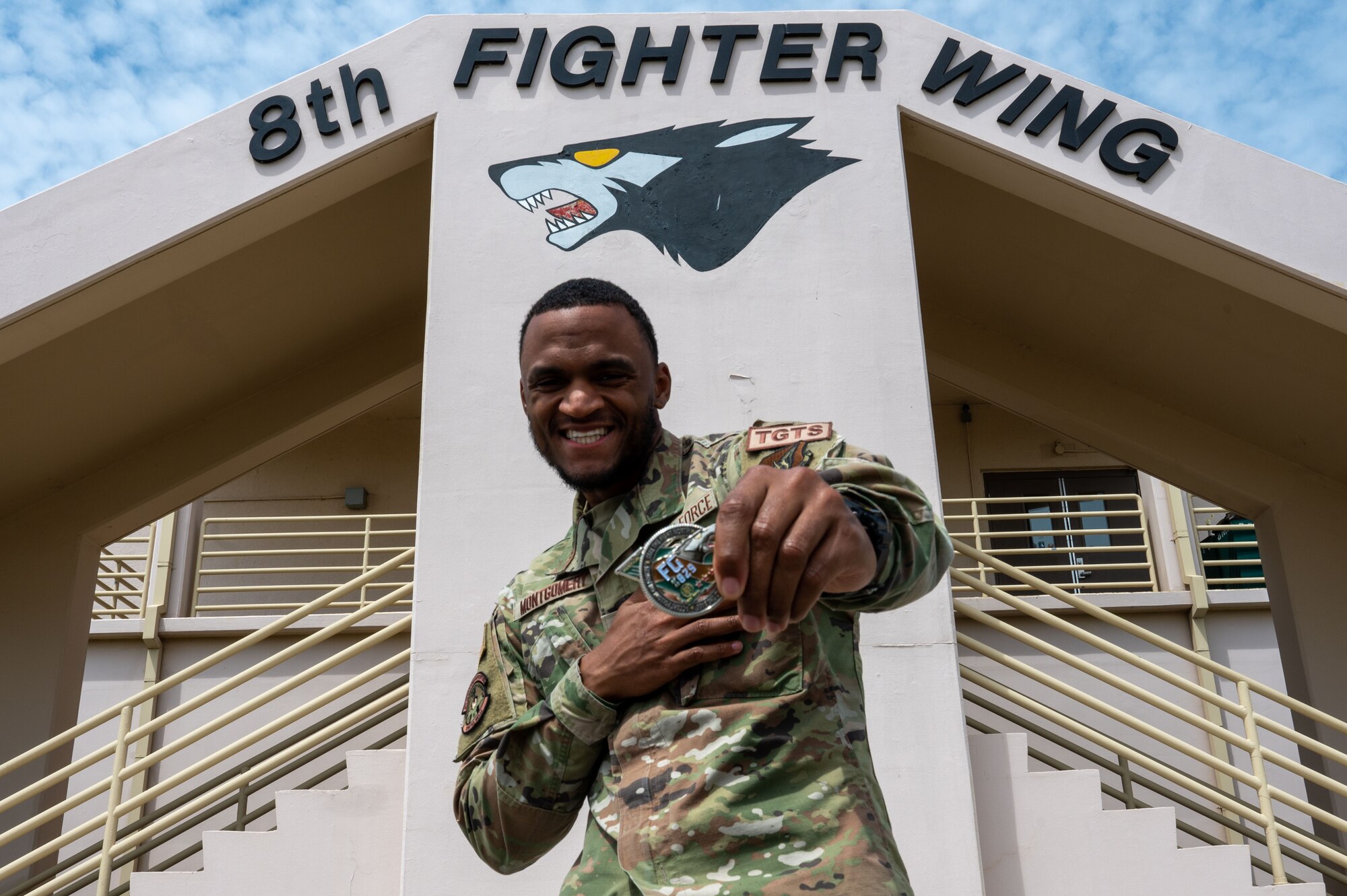 Senior Airman Bryan Montgomery, 8th Operations Support Squadron targeting analyst, poses for a photo (with his team) on Kunsan Air Base, Republic of Korea, April 24, 2023. Pride of the Pack selectees are recognized with a Commander’s coin and a wing wide briefing and discuss their award on AFN Kunsan. (U.S. Air Force photo by Tech. Sgt. Timothy Dischinat).