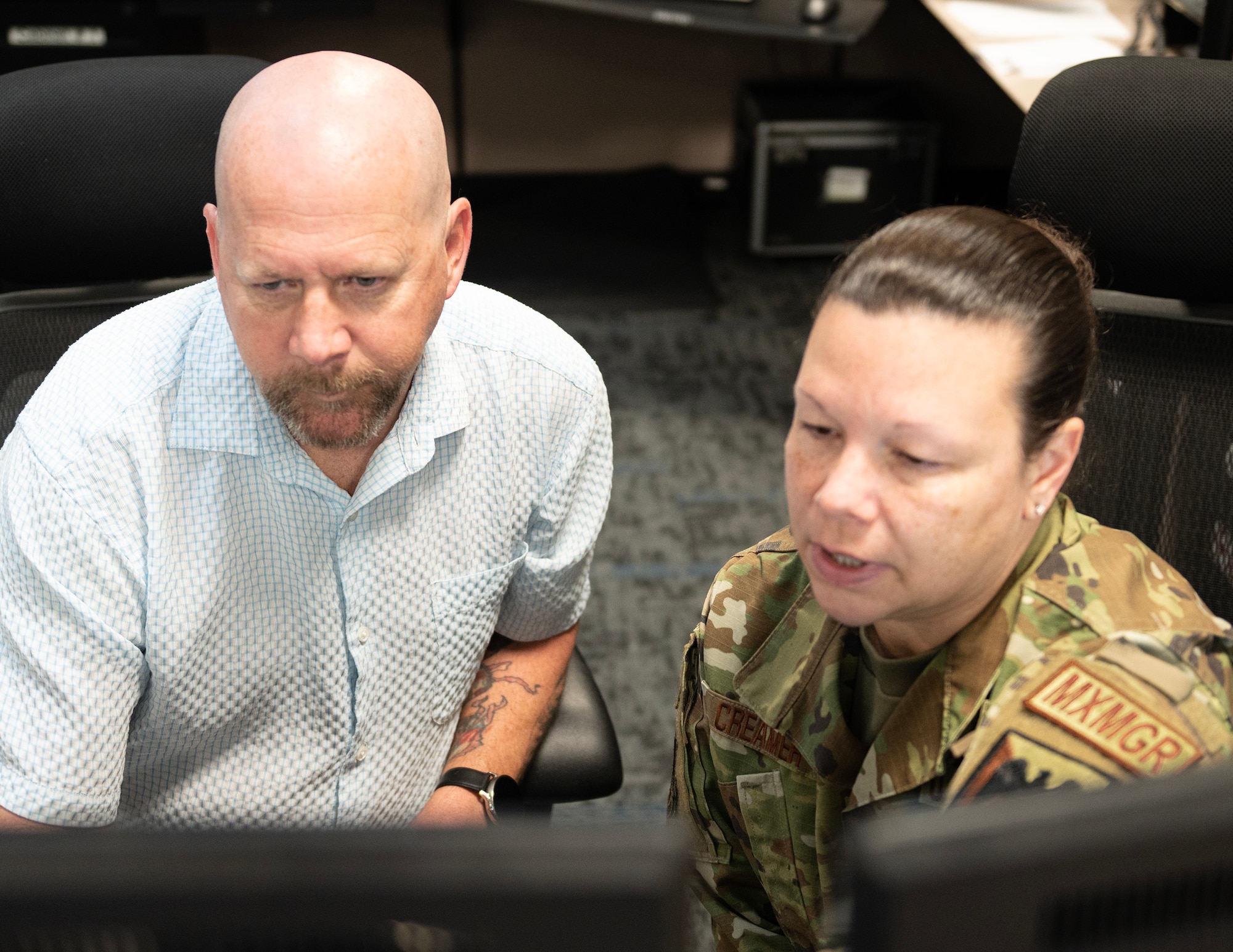 Mr. Paul Jensen, left, 133rd Maintenance Group and U.S. Air Force Senior Master Sgt. Amanda Creamer, Production Assessment Team member, review documentation and Air Force Instructions in St. Paul, April 11, 2023.