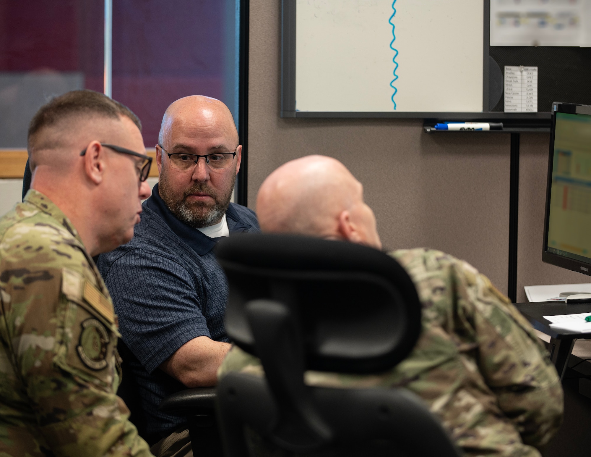 Mr. Dan Mikkelsen, center, 133rd Maintenance Group, talks with U.S. Air Force Senior Master Sgt. Joe Hemphill and U.S. Air Force Senior Master Sgt. Scott Luke in St. Paul, April 11, 2023.