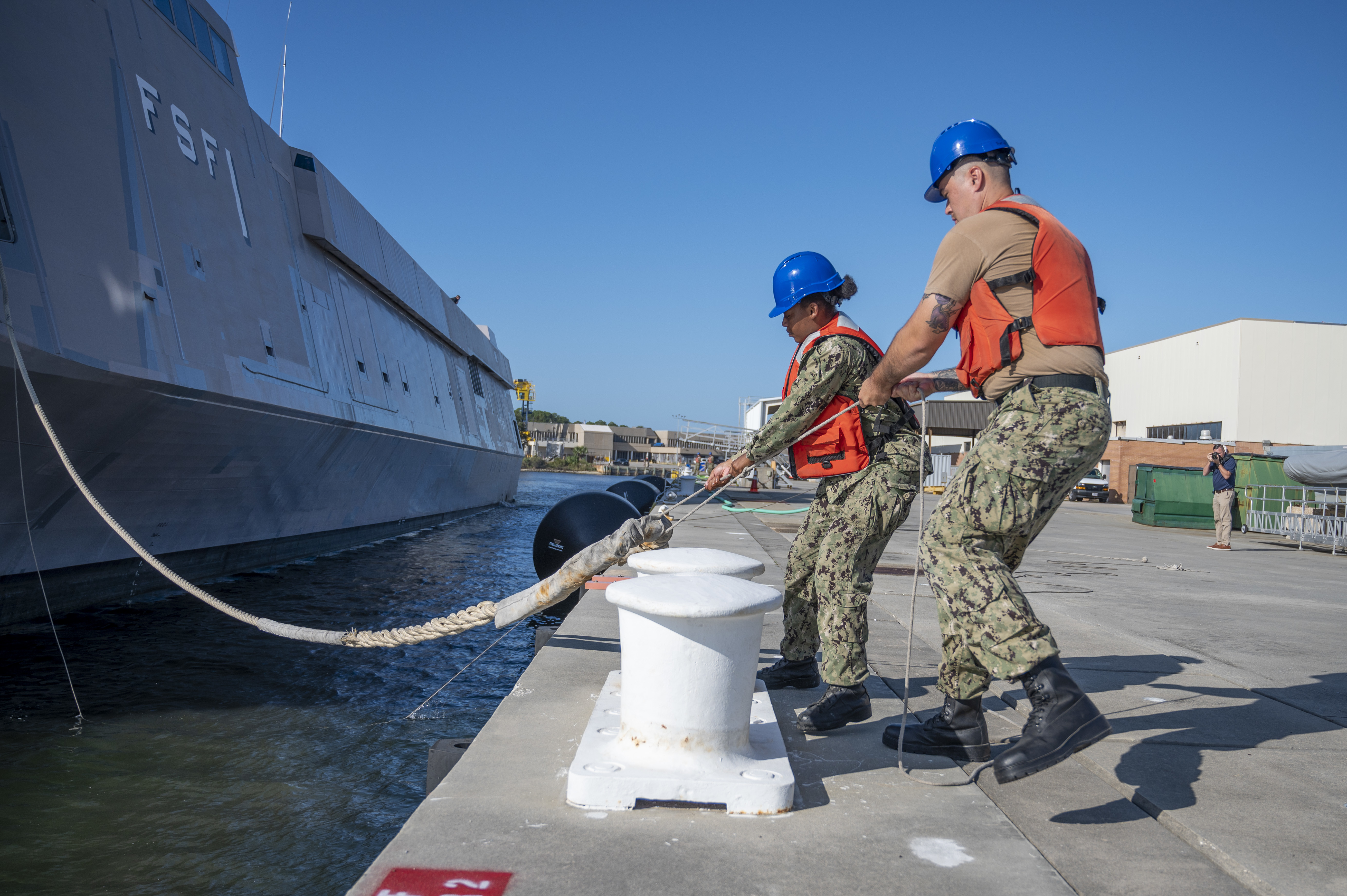 Naval Support Activity Panama City Port Ops Sailors conduct line handling as they moor The Sea Fighter (FSF 1) littoral combat ship pier side.