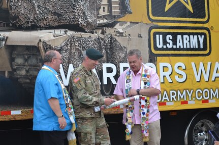 Military member with two Fiesta commission representatives.