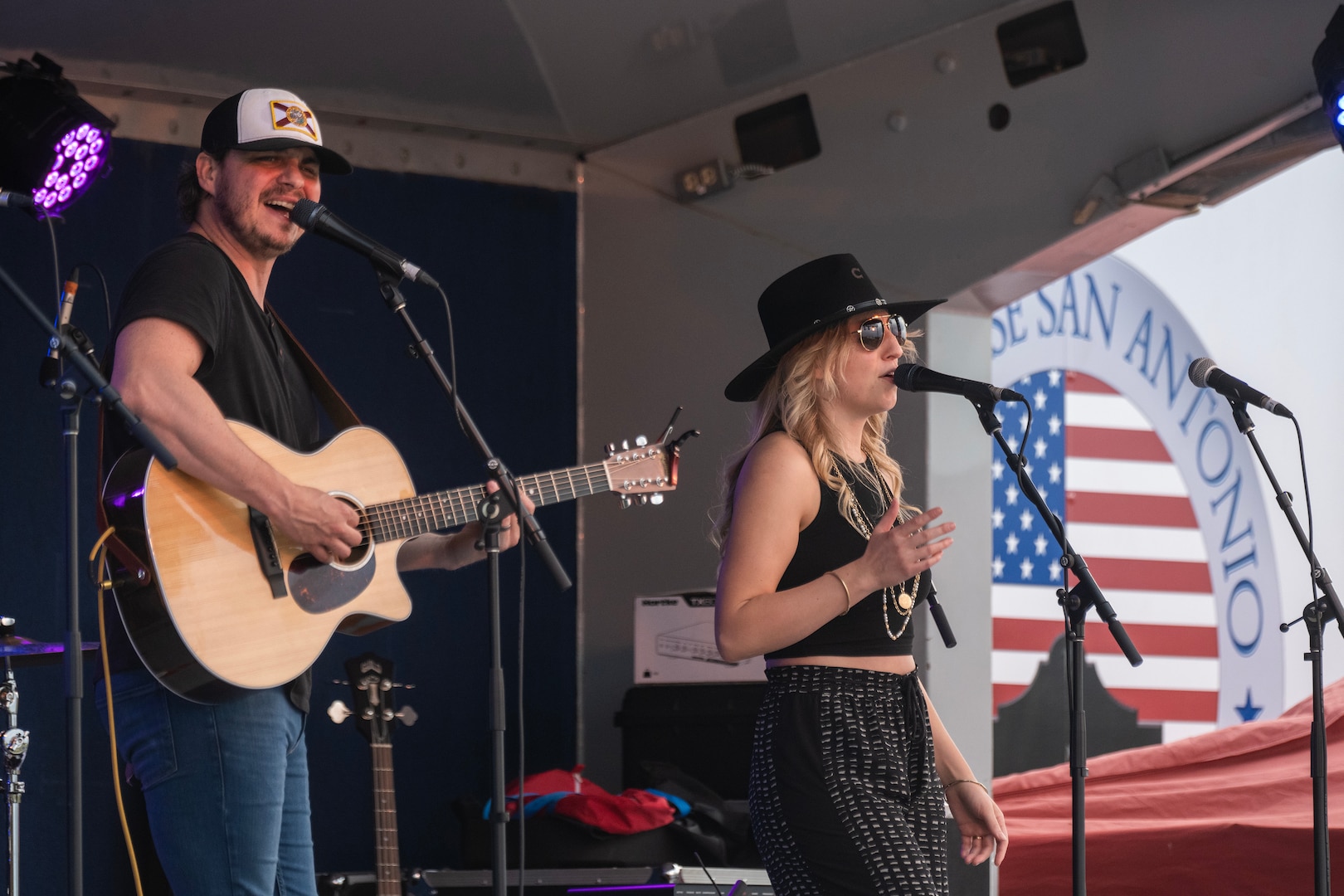 Two people singing on stage