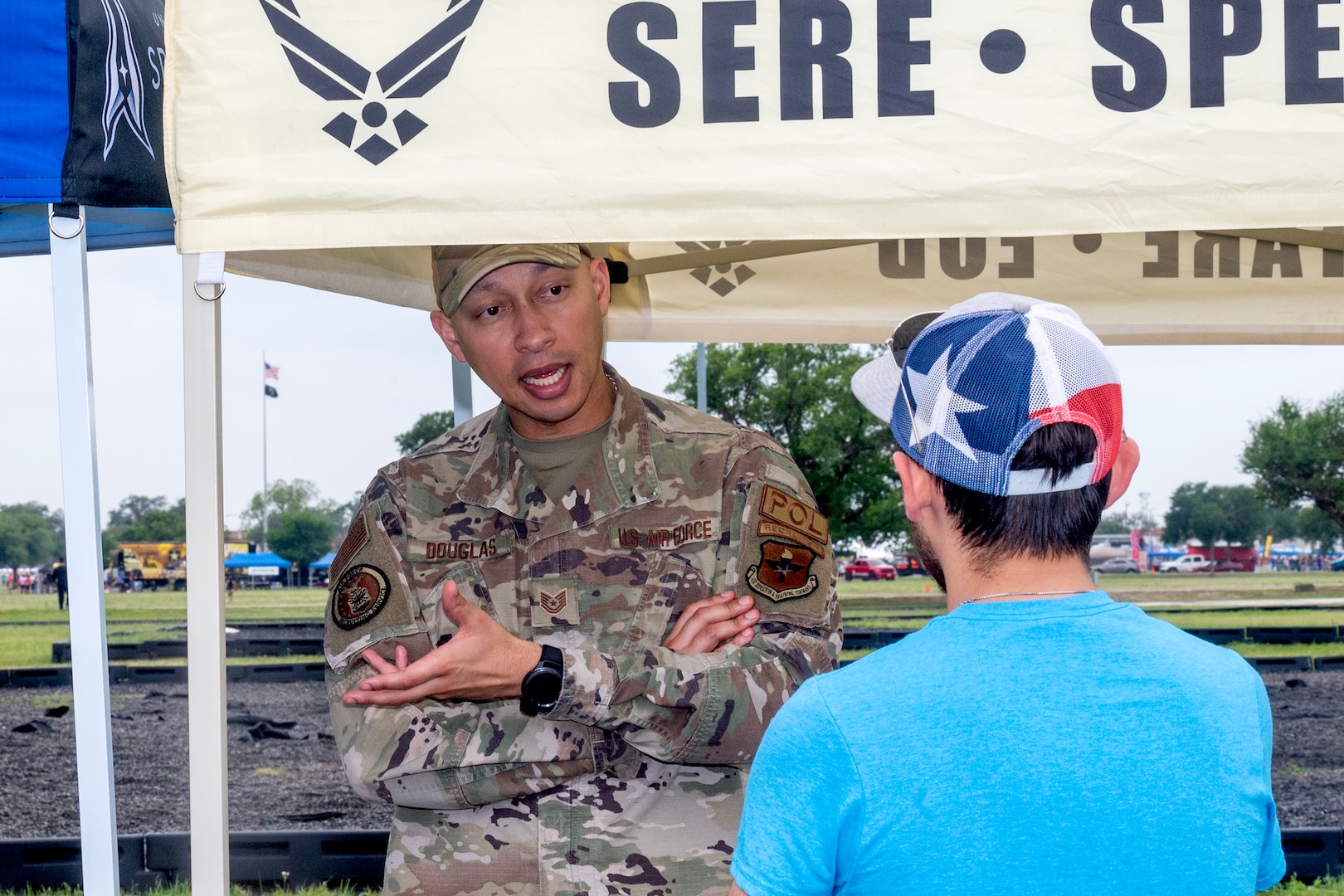 Military member speaking to a young man