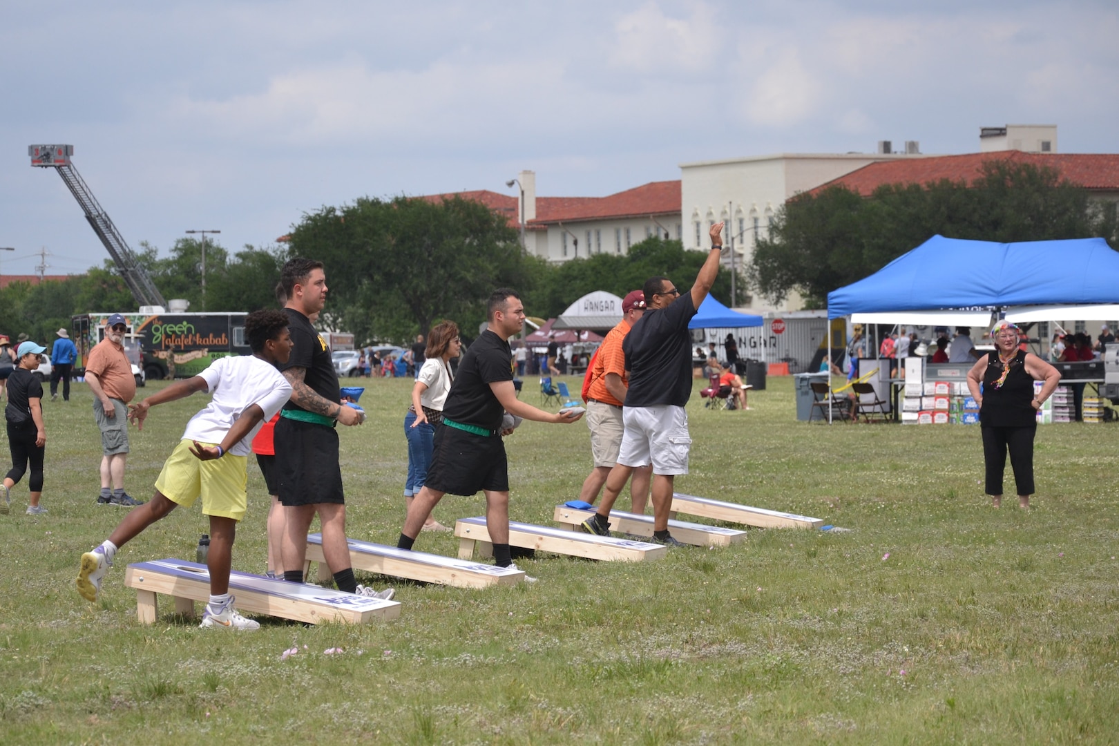 People playing cornhole.