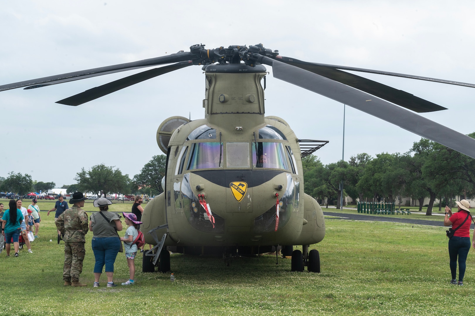 People viewing military Chinook helicopter.