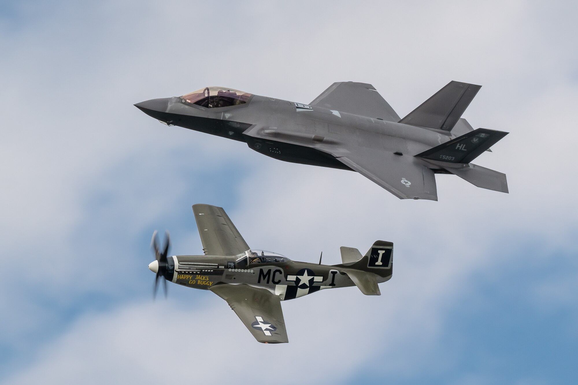 A U.S. Air Force F-35A Lightning II and a historic P-51 Mustang perform a heritage flight over the banks of the Ohio River in downtown Louisville, Ky., April 22, 2023, as part of the annual Thunder Over Louisville air show. This year’s event featured more than 20 military and civilian planes, including a C-130J Super Hercules from the Kentucky Air National Guard, which served as the base of operations for military aircraft participating in the show. (U.S. Air National Guard photo by Dale Greer)