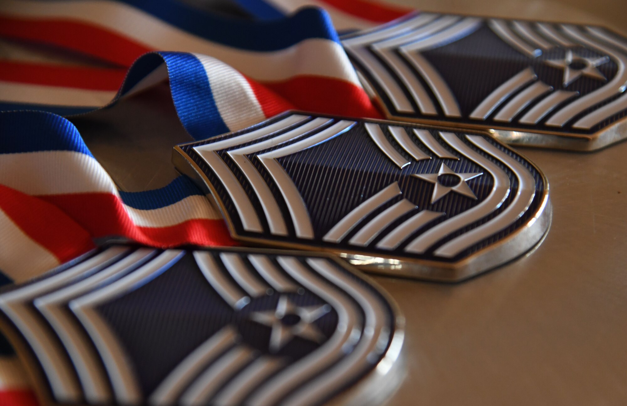 Medallions are on display during the Chief Master Sergeant Recognition Ceremony inside the Bay Breeze Event Center at Keesler Air Force Base, Mississippi, April 20, 2023.