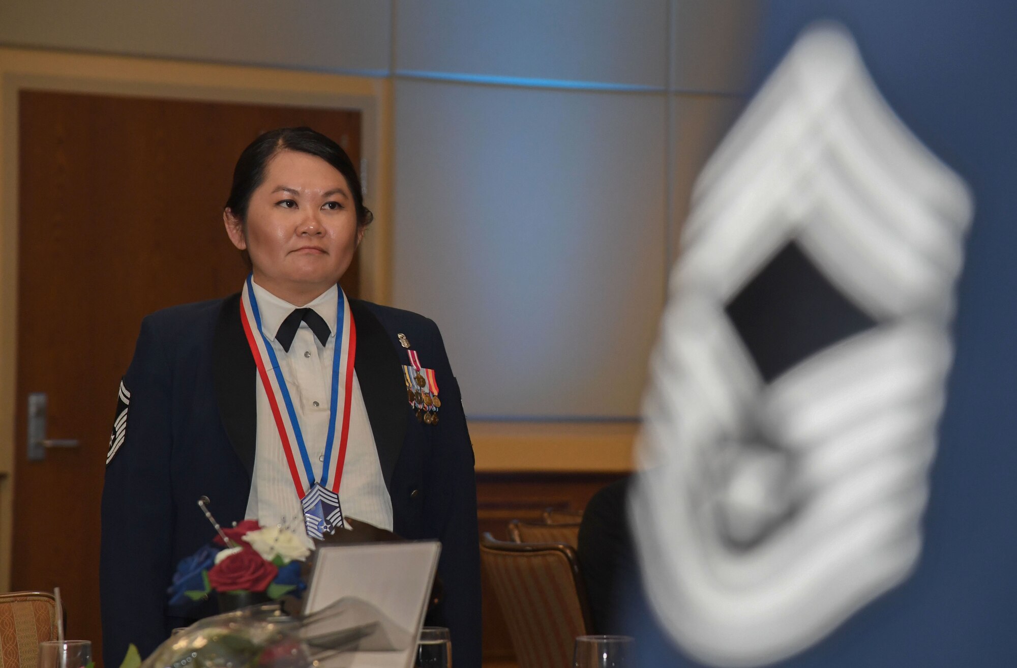 U.S. Air Force Senior Master Sgt. MyTien Pham, 81st Medical Support Squadron senior enlisted leader, stands at attention during the Chief Master Sergeant Recognition Ceremony inside the Bay Breeze Event Center at Keesler Air Force Base, Mississippi, April 20, 2023.