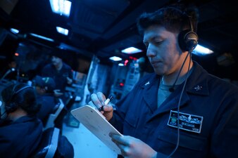 Sonar Technician (Surface) 2nd Class Alejandro Quesada, from Los Angeles, stands watch in the sonar control room during anti-submarine warfare drills aboard the Arleigh Burke-class guided-missile destroyer USS Milius (DDG 69).