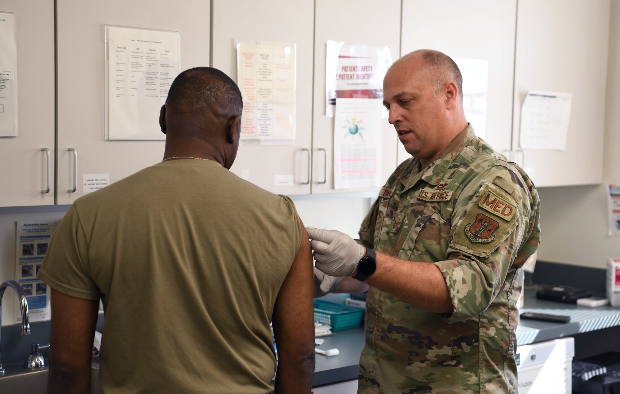 U.S. Air Force Chief Master Sgt. Maurice Williams, left, command chief, Air National Guard, receives his annual influenza vaccination while on a tour of the 178th Wings medical group, Oct. 15, 2022, in Springfield, Ohio. All U.S. military members are required to be vaccinated against influenza to remain mission ready. (U.S. Air National Guard photo by Senior Airman Jillian Maynus).