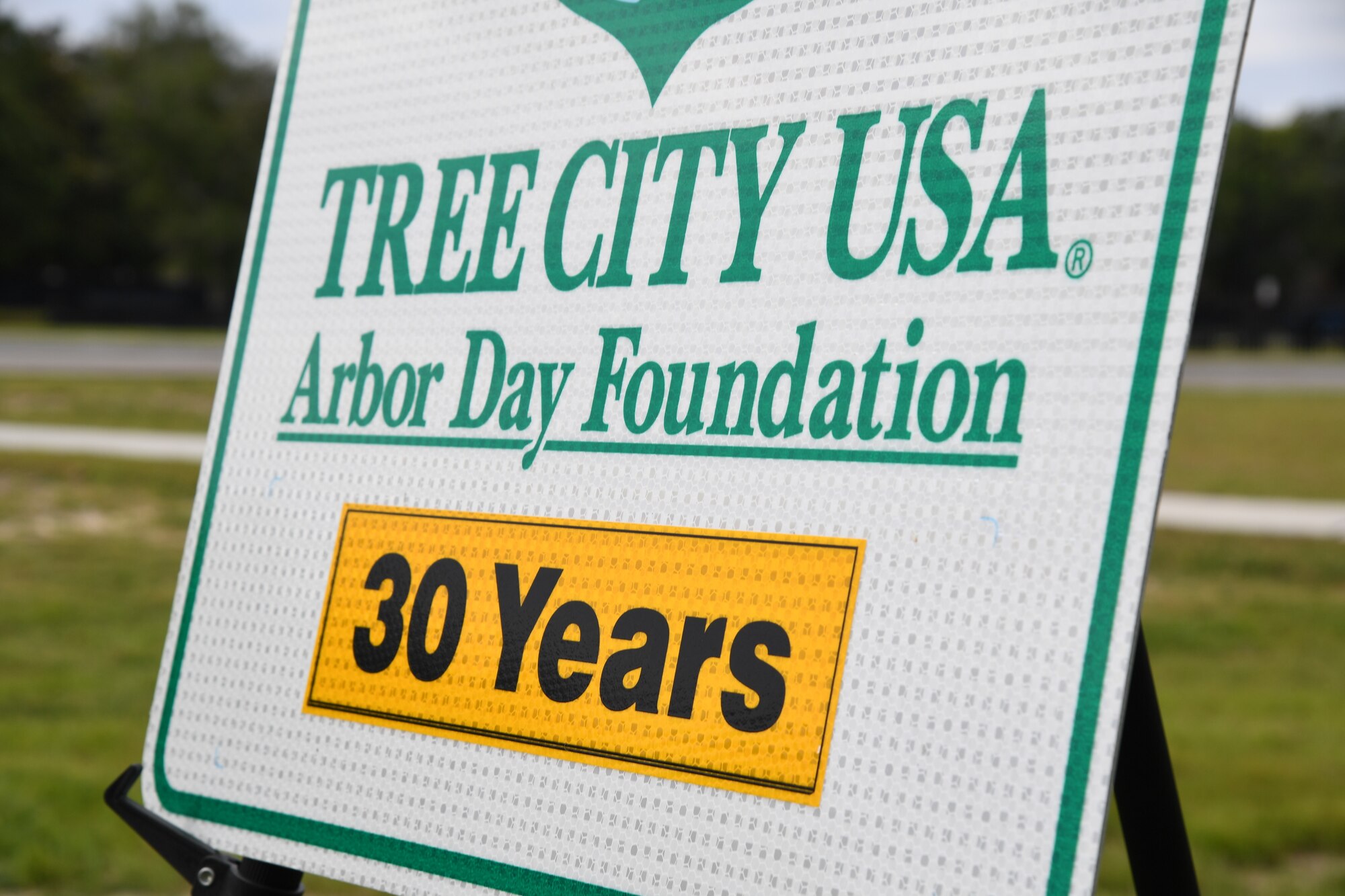 A Tree City USA 30 Year recognition sign is on display during a tree planting ceremony near the Division Street Gate at Keesler Air Force Base, Mississippi, April 24, 2023.