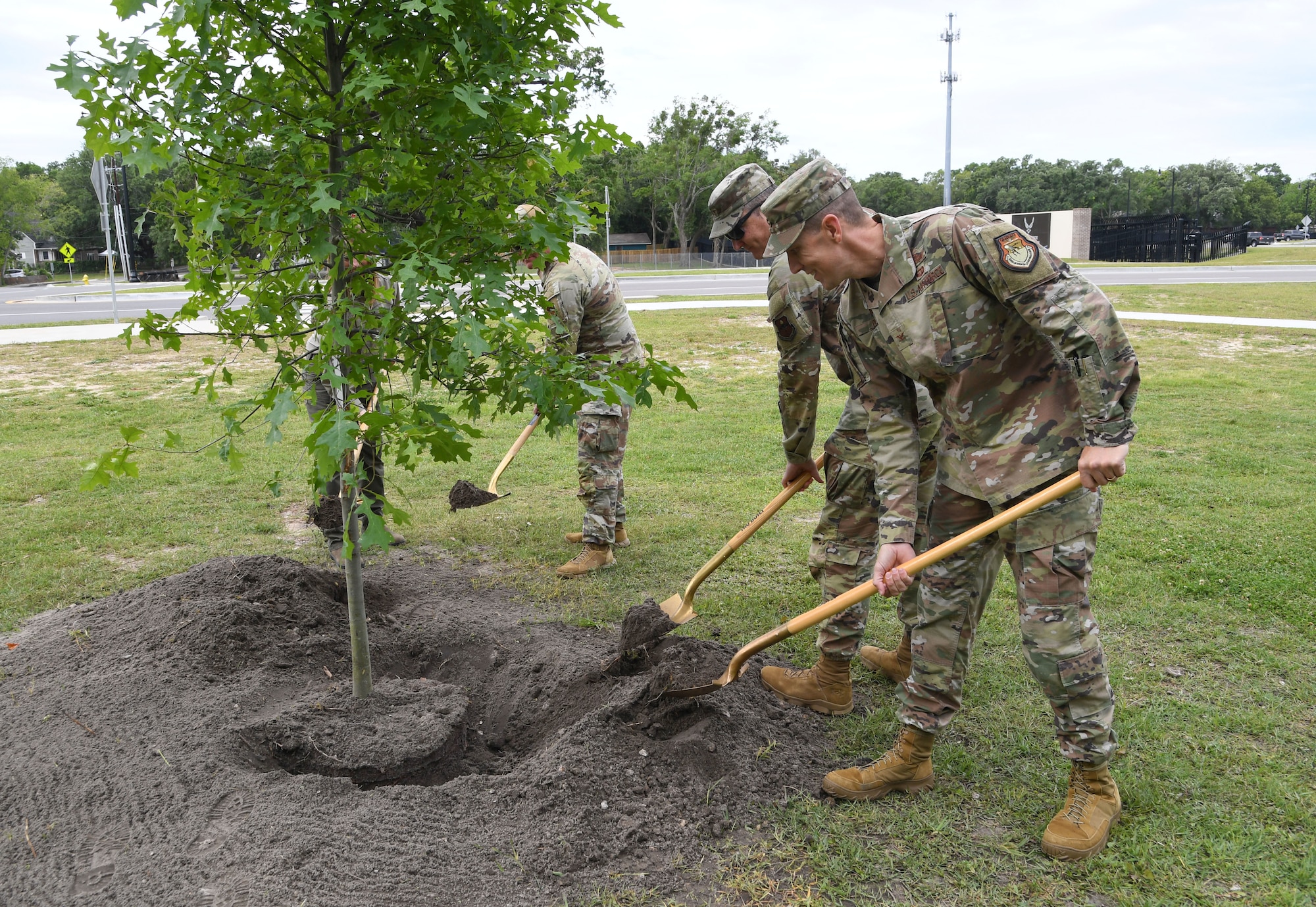 U.S. Air Force Col. Billy Pope, 81st Training Wing commander, participates in a ceremonial tree planting with the assistance of other base leadership near the Division Street Gate at Keesler Air Force Base, Mississippi, April 24, 2023.