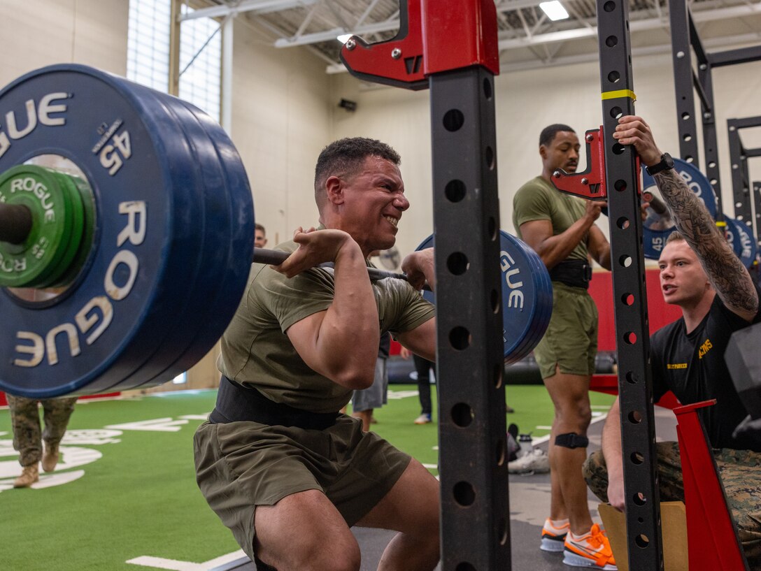 U.S. Marine Corps Staff Sgt. Christopher Thompson, an instructor with Marine Corps Communication-Electronics School, Communication Training Battalion, Twentynine Palms, California, completes a front squat during the “Front Towards the Enemy” event during the first Training and Education Command Fittest Instructor Competition at The Basic School on Marine Corps Base Quantico, Virginia, April 11, 2023. The Marines completed a set of three maximum weight front squats within 10 minutes and were scored in reference to their individual body weight.